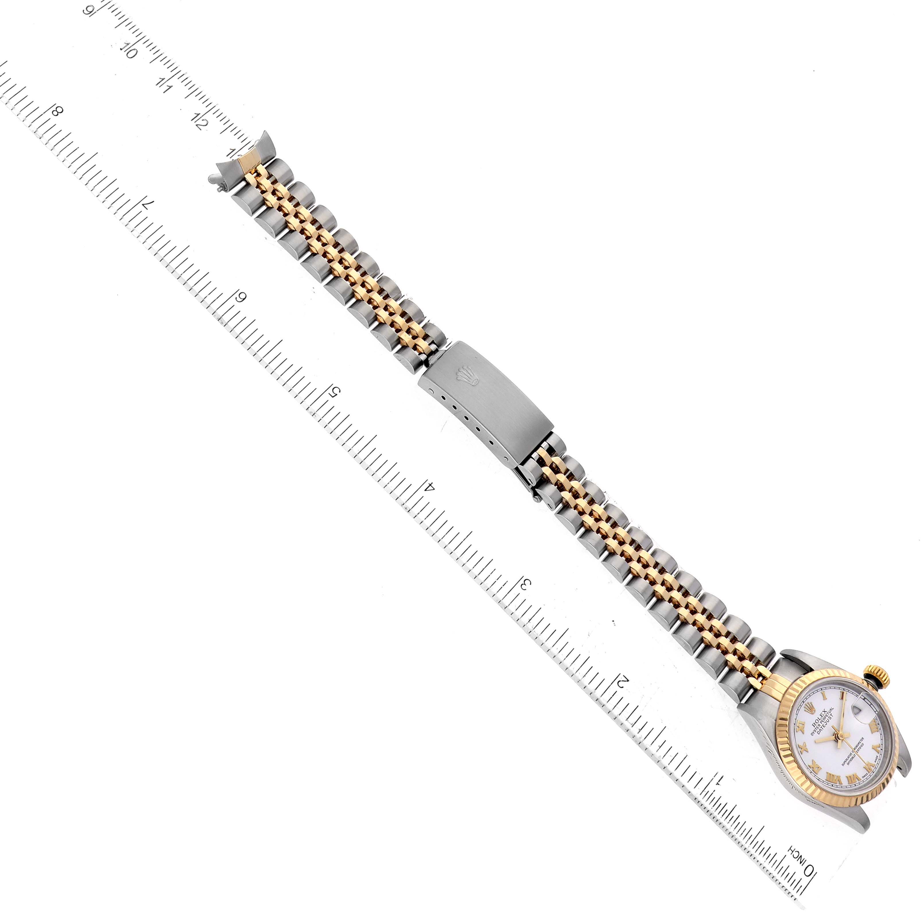 The image shows the Rolex Datejust 79173 Women's Steel and Gold (two tone) White Dial 79173 Women's Steel and Gold (two tone) White Dial watch from an overhead angle, highlighting the bezel, dial, and metal bracelet with a clasp.