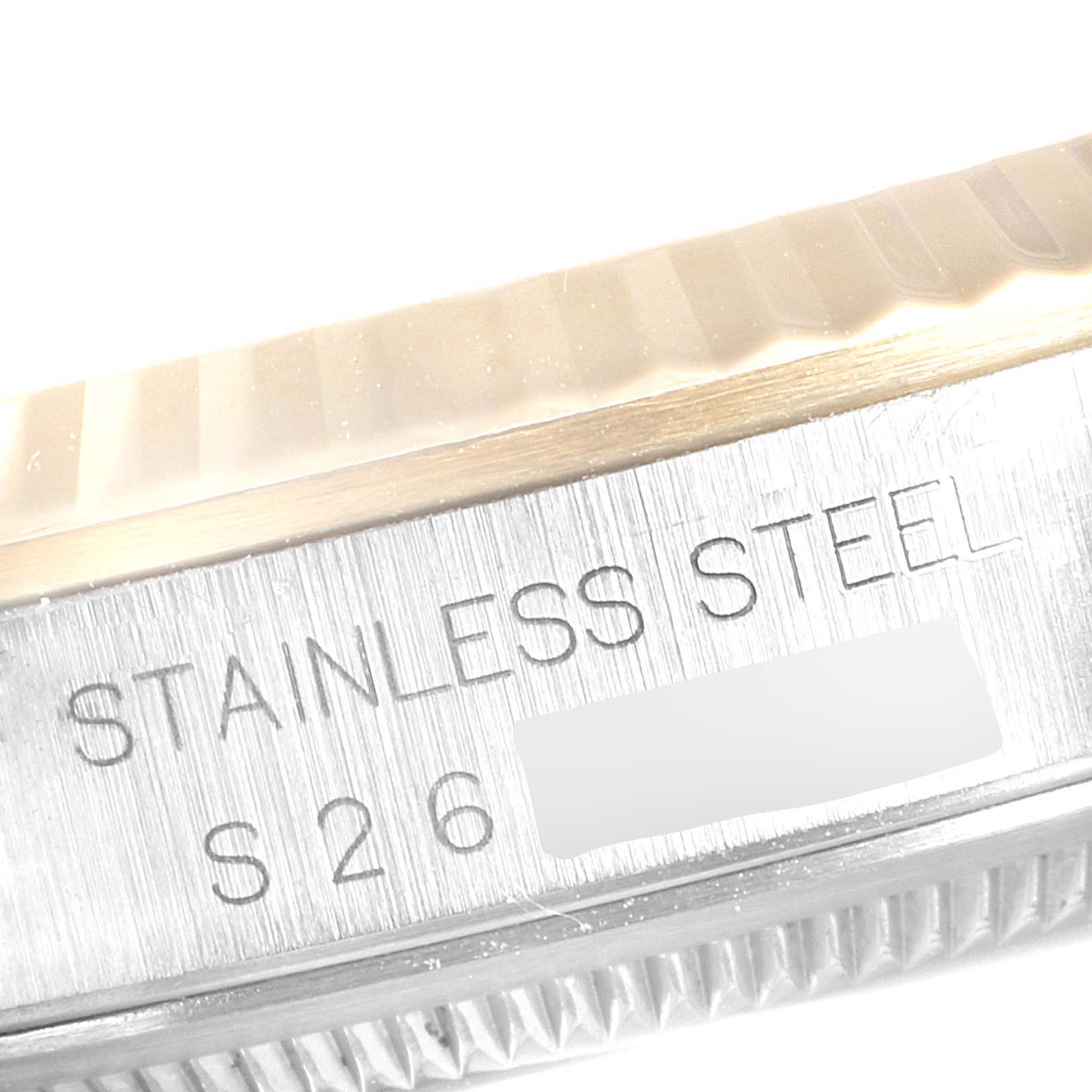 The image shows a close-up view of the stainless steel case side of a Rolex Datejust 16233 Men
s Steel and Gold (two tone) White Dial 16233 Men
s Steel and Gold (two tone) White Dial watch, featuring engraving details.