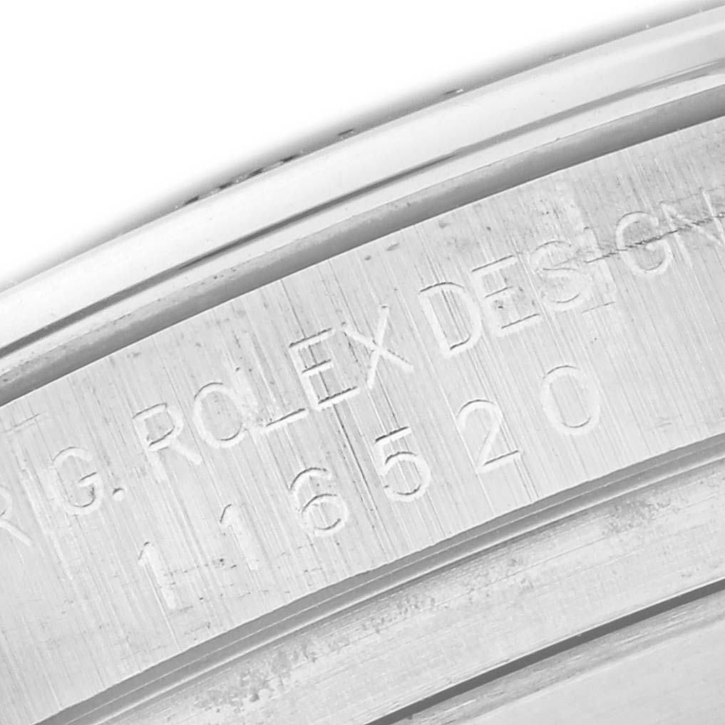 The image shows a close-up of the engraved inner bezel or rehaut of a Rolex Daytona 116520 Men
s Stainless Steel White Dial watch.