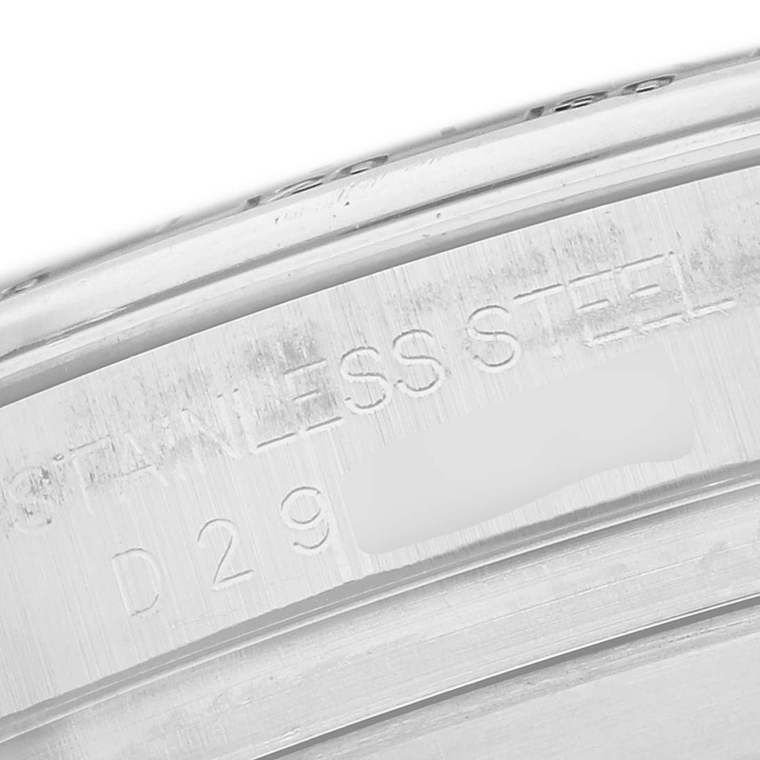 The image shows a close-up of the inner case edge with engravings on a Rolex Daytona 116520 Men
s Stainless Steel White Dial watch.