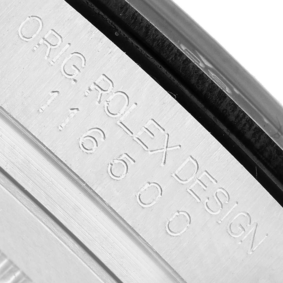 The image shows an engraved side view of the case with the text "ORIG ROLEX DESIGN 116500" on the Rolex Daytona 116500LN Men's Stainless Steel Black Dial model.