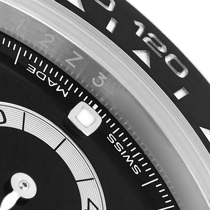 The image shows a close-up of the Rolex Daytona 116500LN Men's Stainless Steel Black Dial watch, highlighting the bezel and part of the dial.