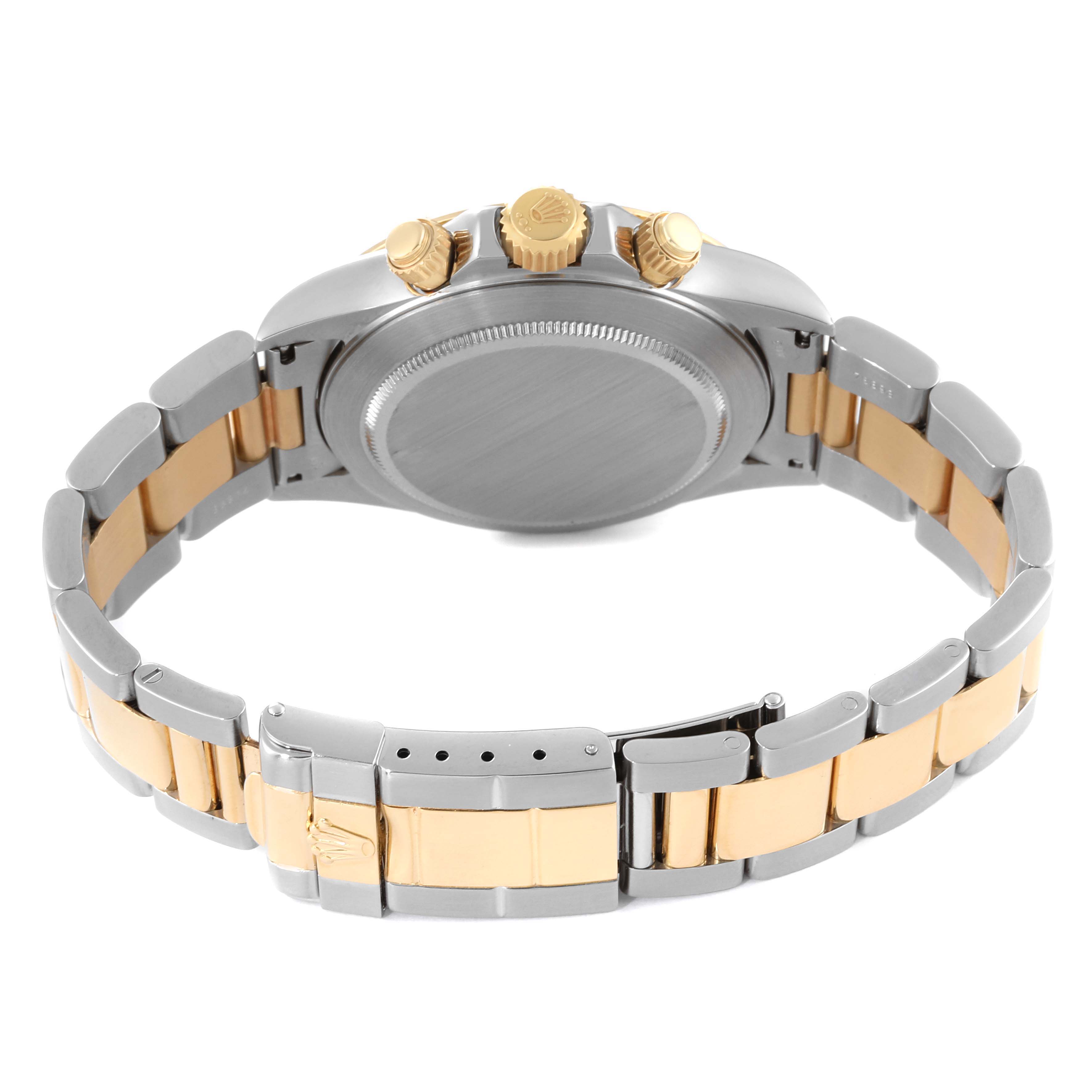 This image shows the back view of a Rolex Daytona 16523 Men
s Steel and Gold (two tone) White Dial 16523 Men
s Steel and Gold (two tone) White Dial watch, highlighting the case back, crown, pushers, and two-tone bracelet.