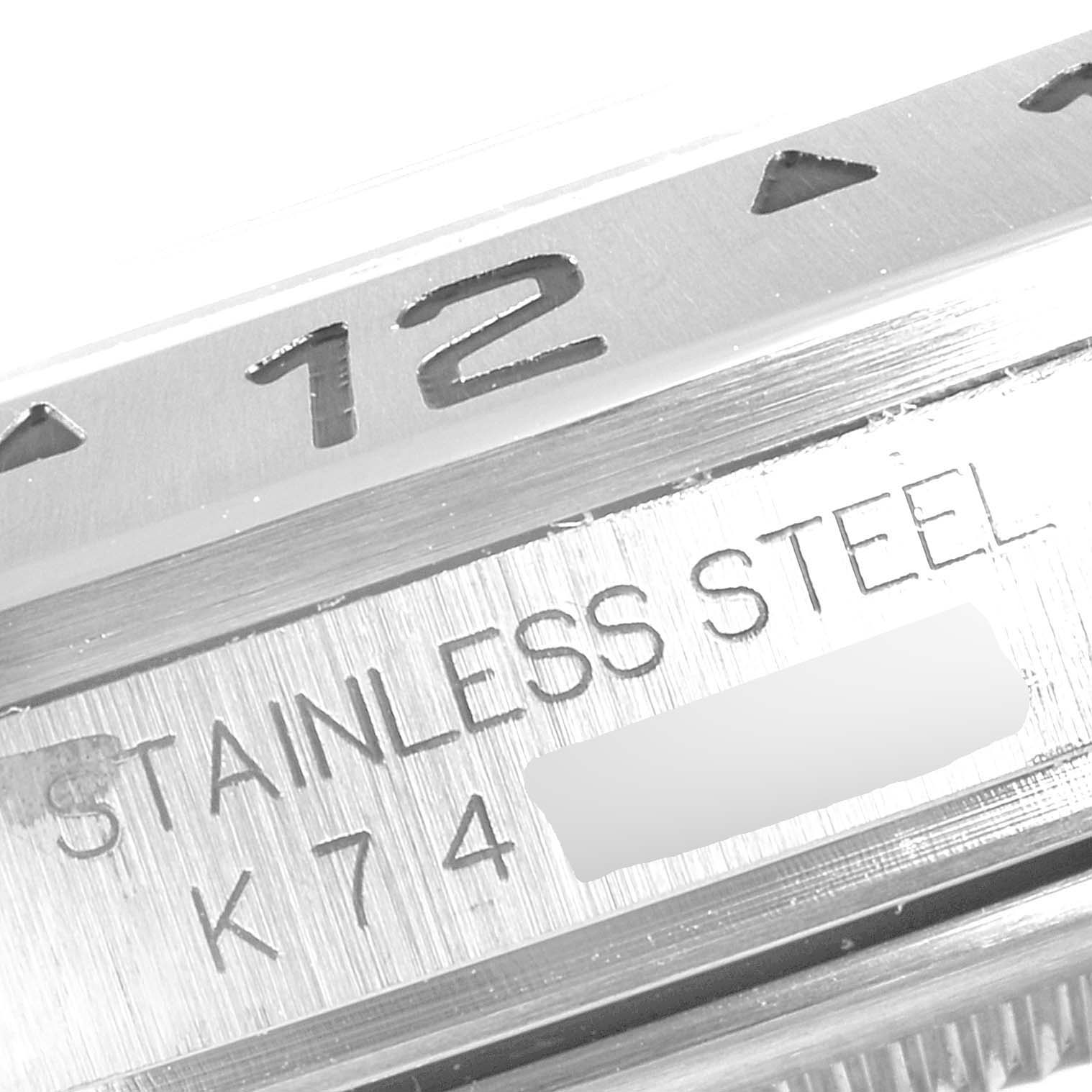 Close-up image of the Rolex Explorer 16570 Men
s Stainless Steel Black Dial 16570 Men
s Stainless Steel Black Dial watch, showcasing the stainless steel casing and partial view of the bezel with the number 12.