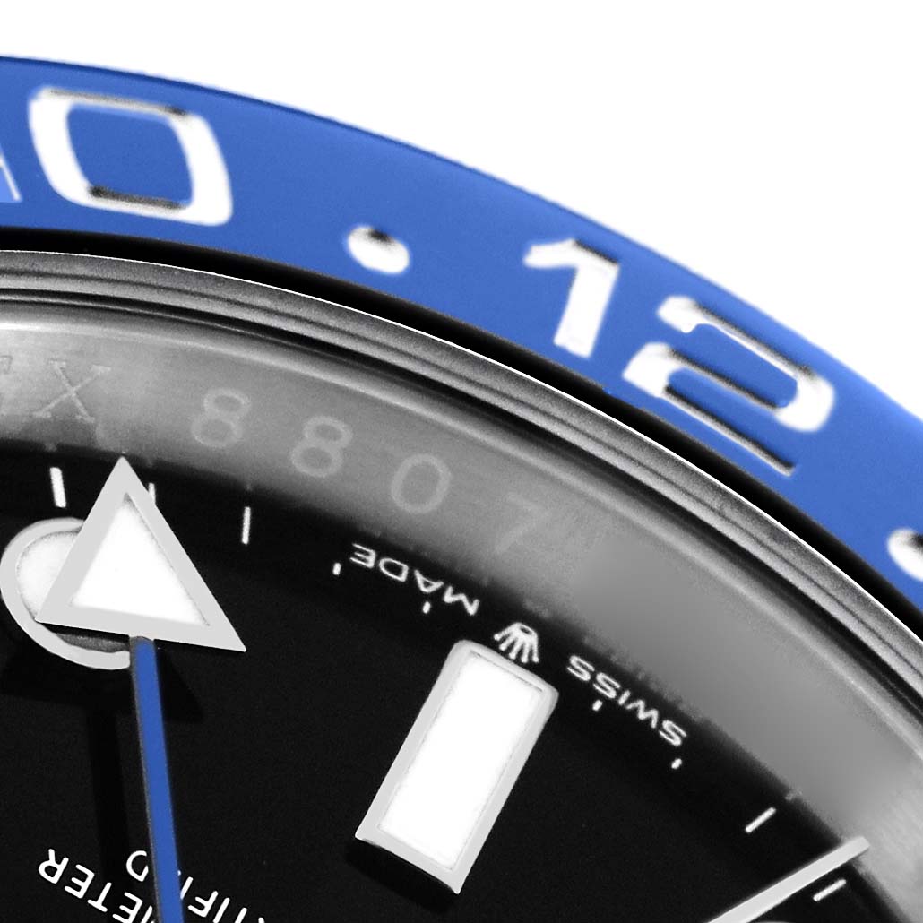 The image shows a close-up of the bezel, dial, and part of the hands of a Rolex GMT-Master 126710 Men
s Stainless Steel Black Dial.