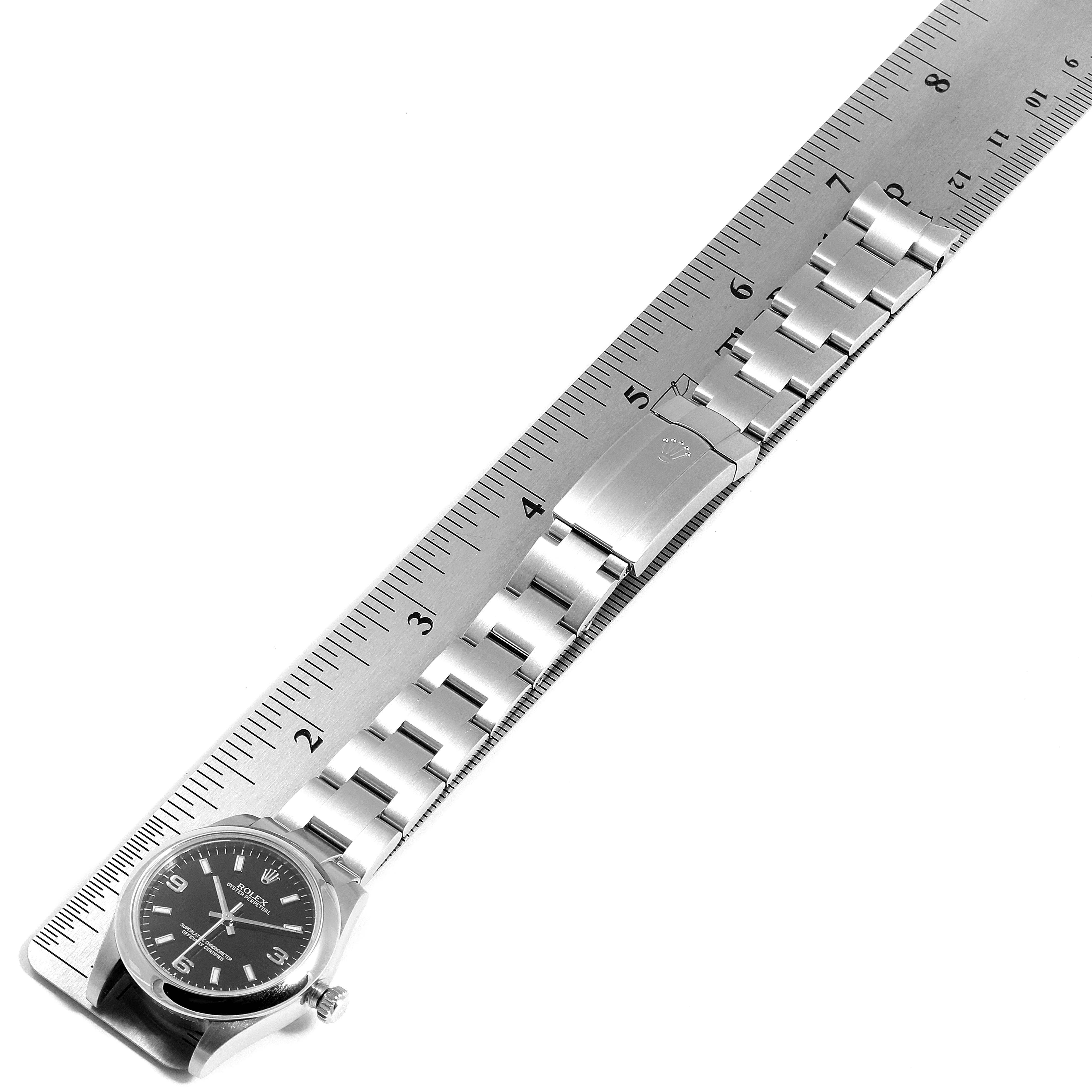 The photo shows a Mid-Size Rolex watch, including the face, bracelet, and clasp, measured alongside a ruler.