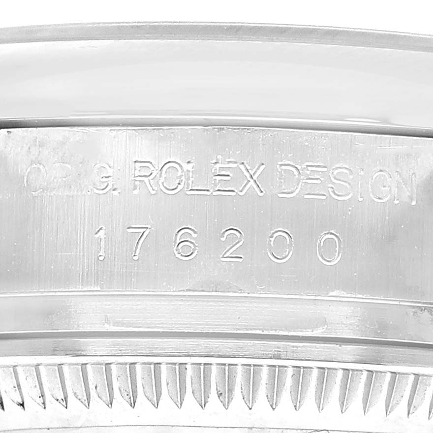 The image shows the side of a Rolex Oyster Perpetual 176200 Women's Stainless Steel Silver Dial watch case, featuring engraved model information.