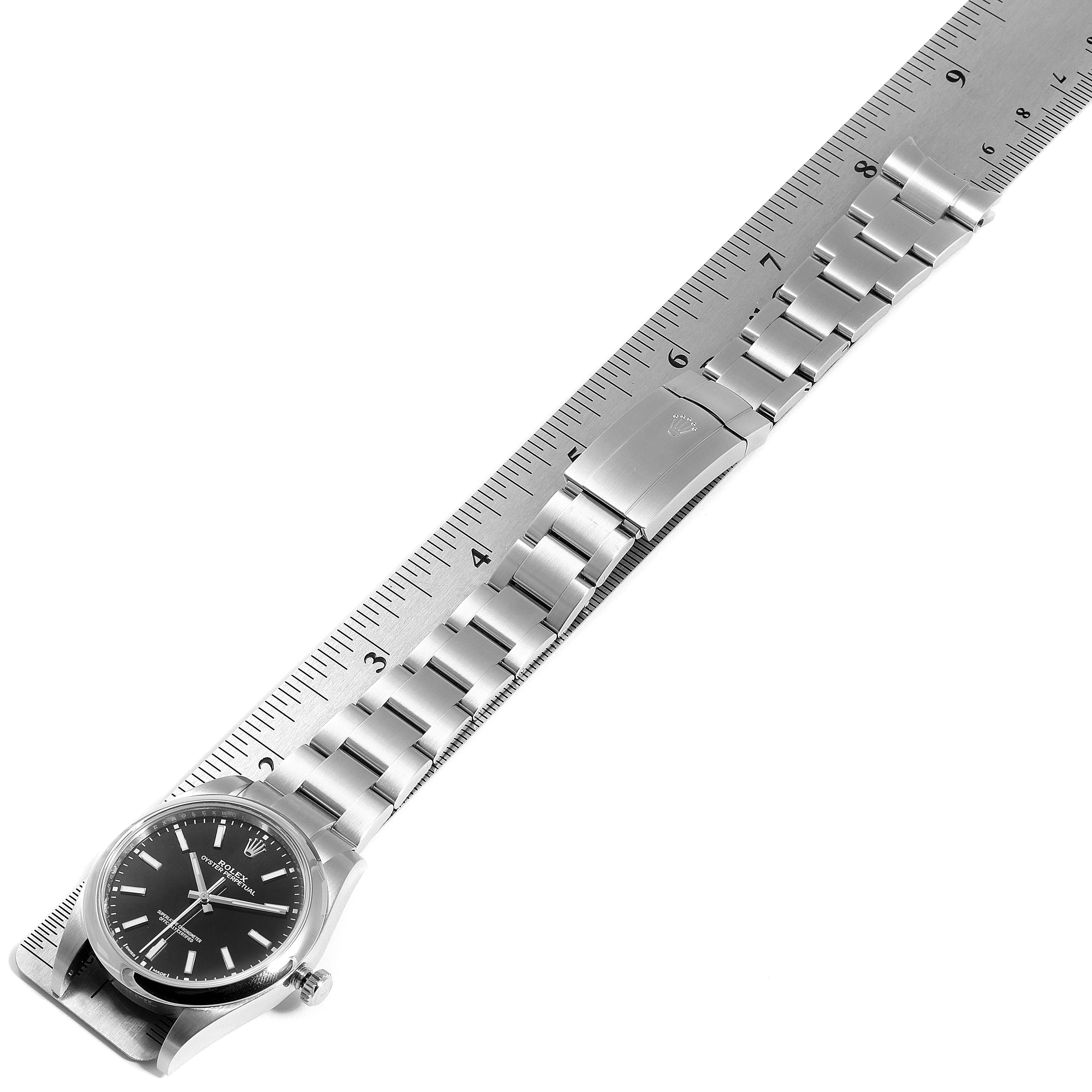 The image shows a top-down view of a Rolex Oyster Perpetual 114300 Men's Stainless Steel Black Dial 114300 Men's Stainless Steel Black Dial watch, displaying the watch face and the full metal bracelet.