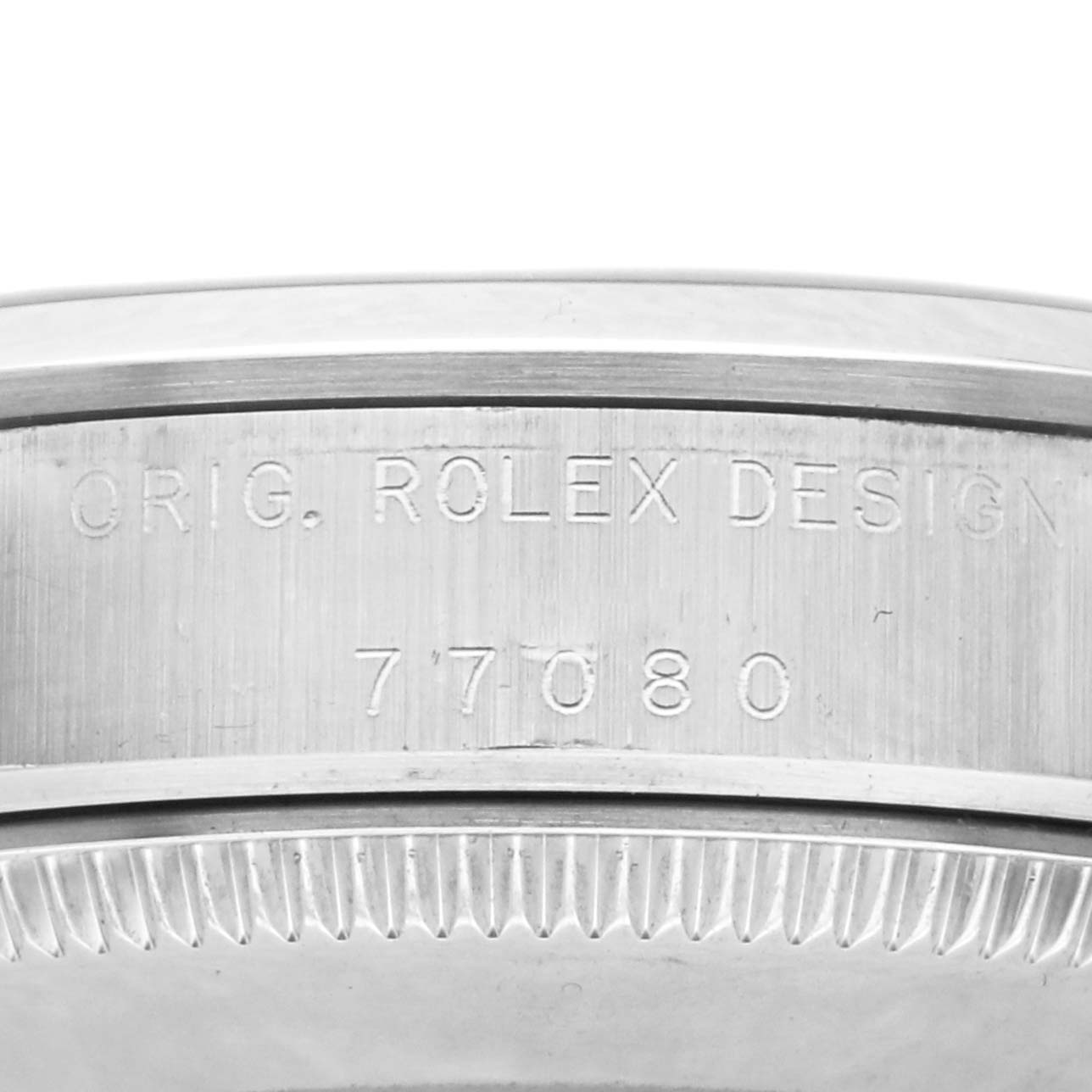 The image shows a close-up of the side of a Rolex Mid-Size 77080 Women's Stainless Steel Pink Dial 77080 Women's Stainless Steel Pink Dial watch case with the engraved design and model number, "77080".