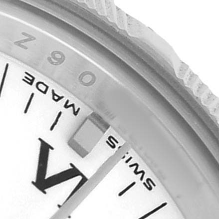 The image shows a close-up of the Rolex Oyster Perpetual 176210 Women's Stainless Steel White Dial's bezel edge and part of the dial, featuring the word "SWISS" and markings.