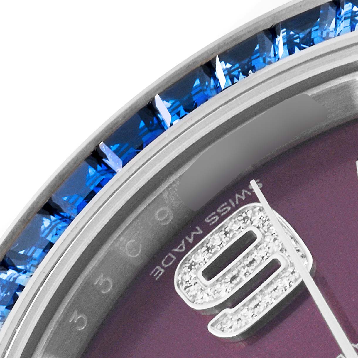 This is a close-up of the bezel and dial of a Rolex Pearlmaster 86349SAFUBL Men
s White Gold Purple Dial 86349SAFUBL Men
s White Gold Purple Dial watch, showing the gemstones and part of the numeral 9.