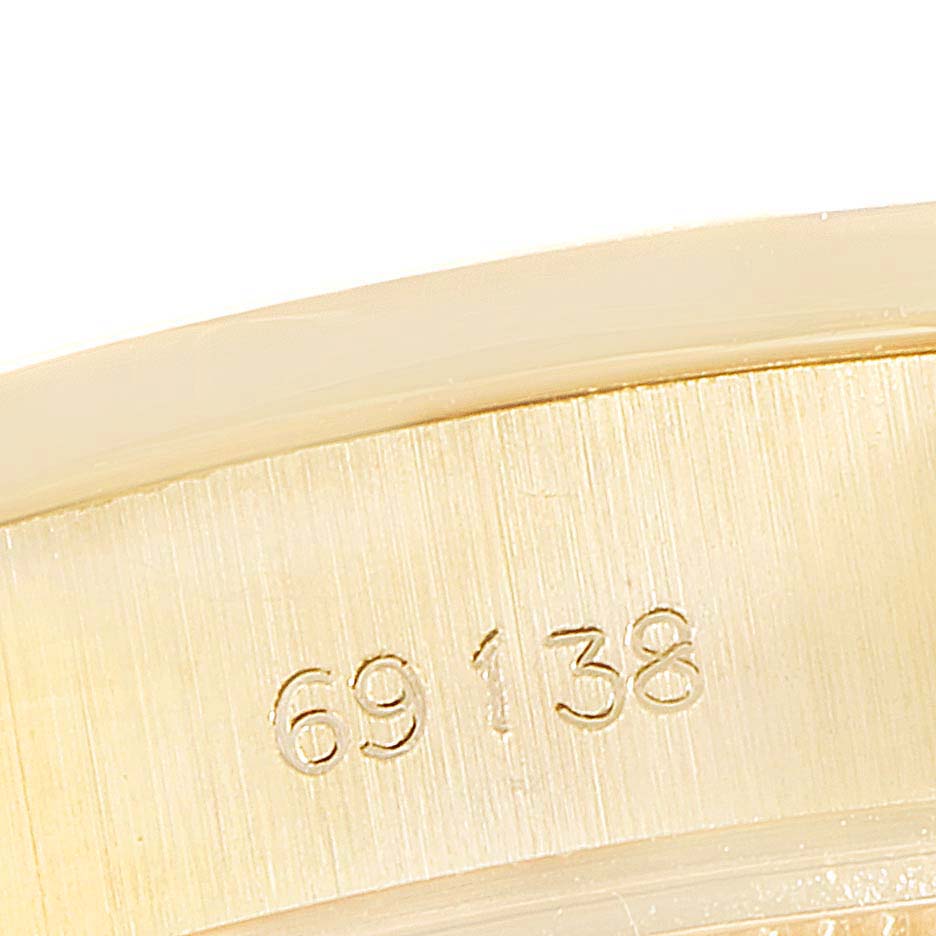 This close-up image shows the model number "69138" engraved on the case of a Rolex President 69138 Women
s Yellow Gold Champagne Dial 69138 Women
s Yellow Gold Champagne Dial watch.