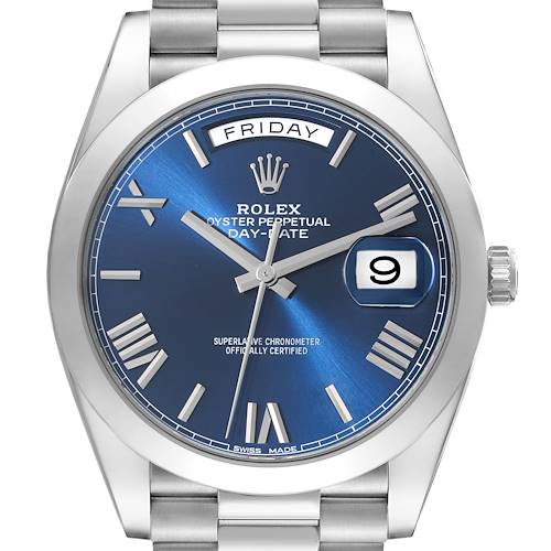 The image shows a front view of the Rolex President Day-Date watch with a blue dial, Roman numerals, and stainless steel bracelet.