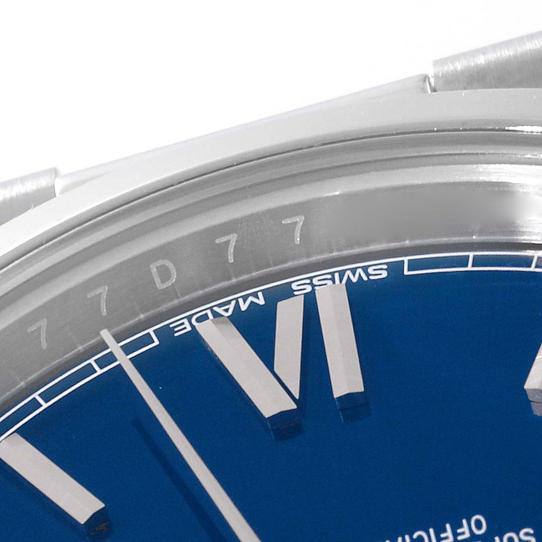 This image shows a close-up of the dial and partially the bezel of a Rolex President 228206 Men
s Platinum Blue Dial 228206 Men
s Platinum Blue Dial model watch, highlighting the "SWISS MADE" inscription.