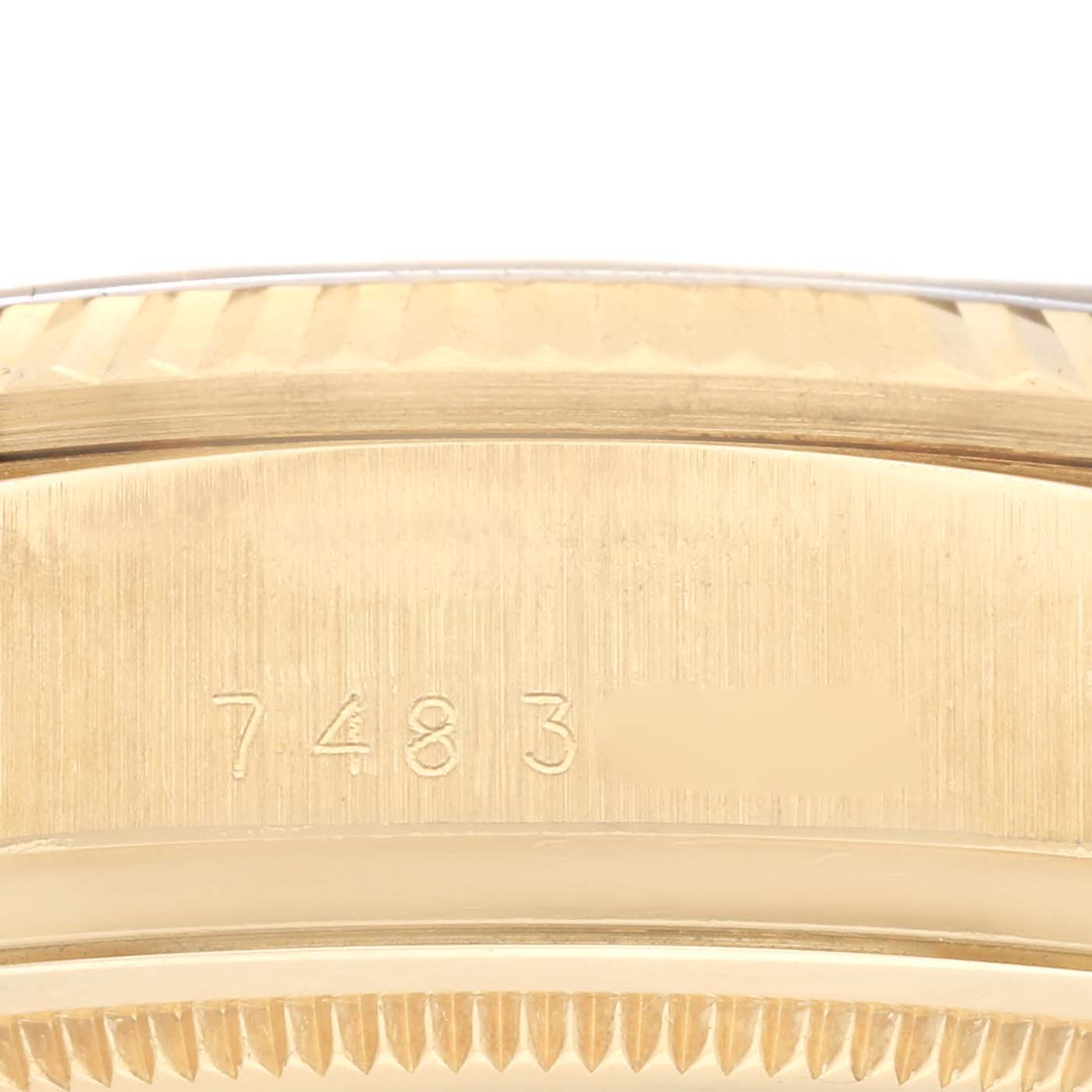 The image shows a close-up angled view of the lug area on a Rolex President 18038 Men's Yellow Gold Black Dial 18038 Men's Yellow Gold Black Dial model, focusing on its engraved serial number.
