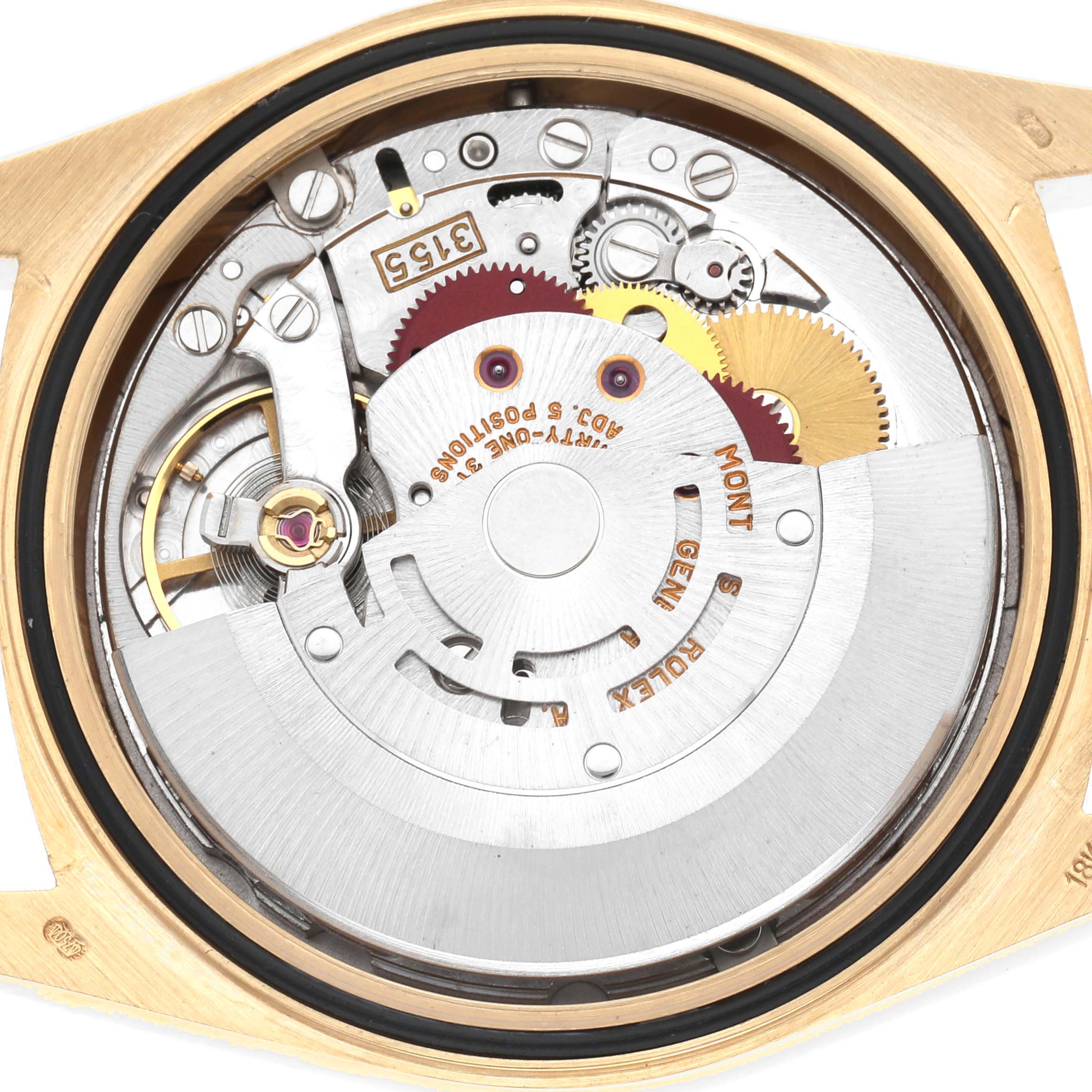The image shows the movement of a Rolex President 18238 Men
s Yellow Gold Champagne Dial model watch from the back, highlighting gears and components.