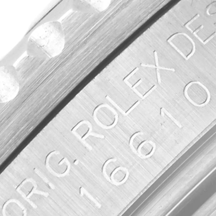This close-up image shows the side engraving and a portion of the bezel of the Rolex Submariner 16610 Men's Stainless Steel Black Dial 16610 Men's Stainless Steel Black Dial watch.