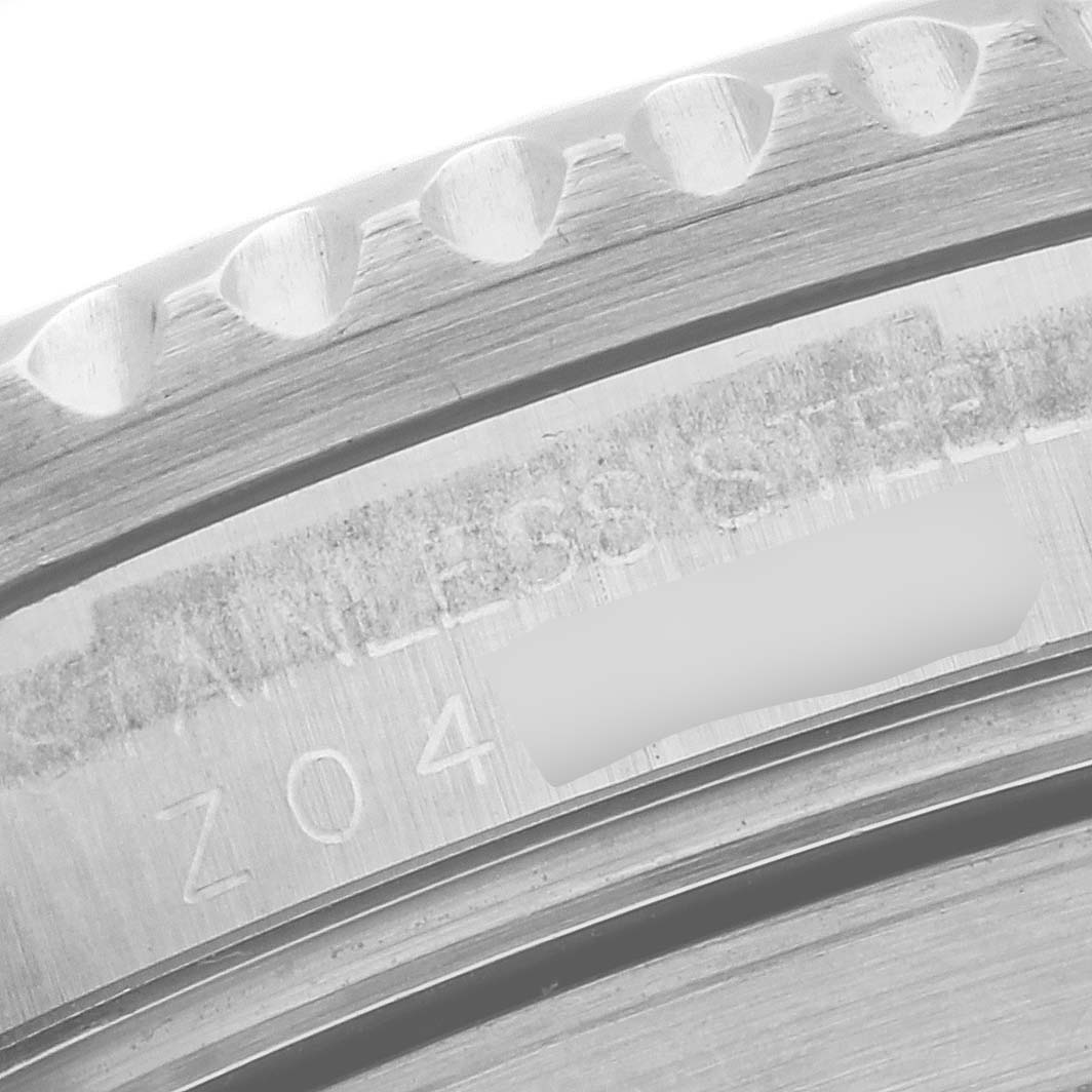 This close-up image of a Rolex Submariner 16610 Men's Stainless Steel Black Dial 16610 Men's Stainless Steel Black Dial watch shows the engraved text on the stainless steel case back.