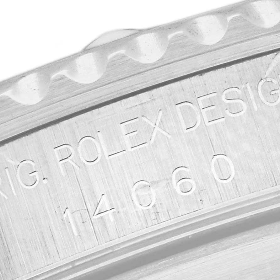 The image shows an angled close-up of the engraved serial number and design details on the bezel of a Rolex Submariner 14060 Men's Stainless Steel Black Dial 14060 Men's Stainless Steel Black Dial watch.
