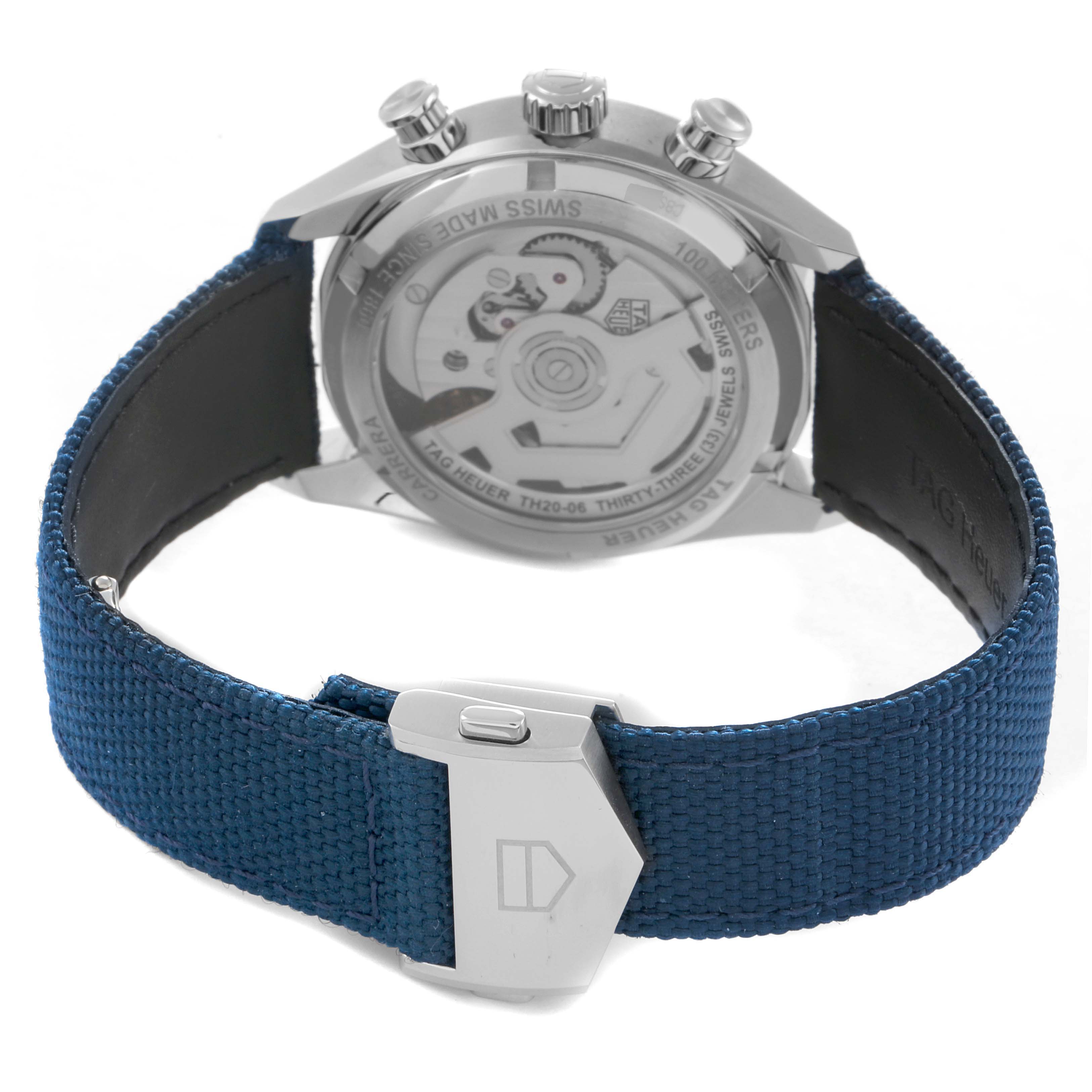 The image shows the back of a Tag Heuer Carrera CBS2213 Men
s Stainless Steel Blue Dial watch with a view of the movement and a blue fabric strap.