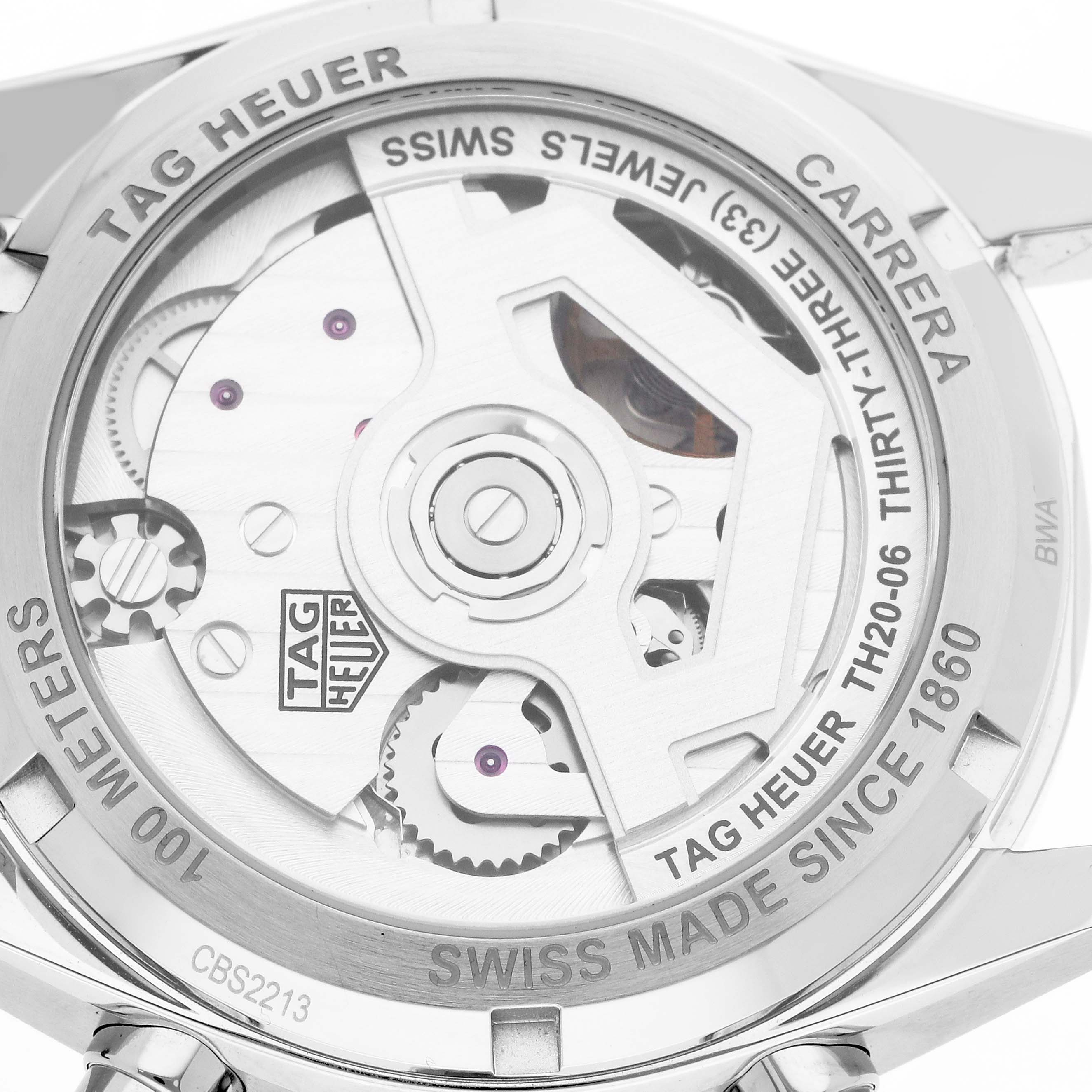 The image shows the back of a Tag Heuer Carrera CBS2213 Men
s Stainless Steel Blue Dial watch, revealing its movement and engravings.