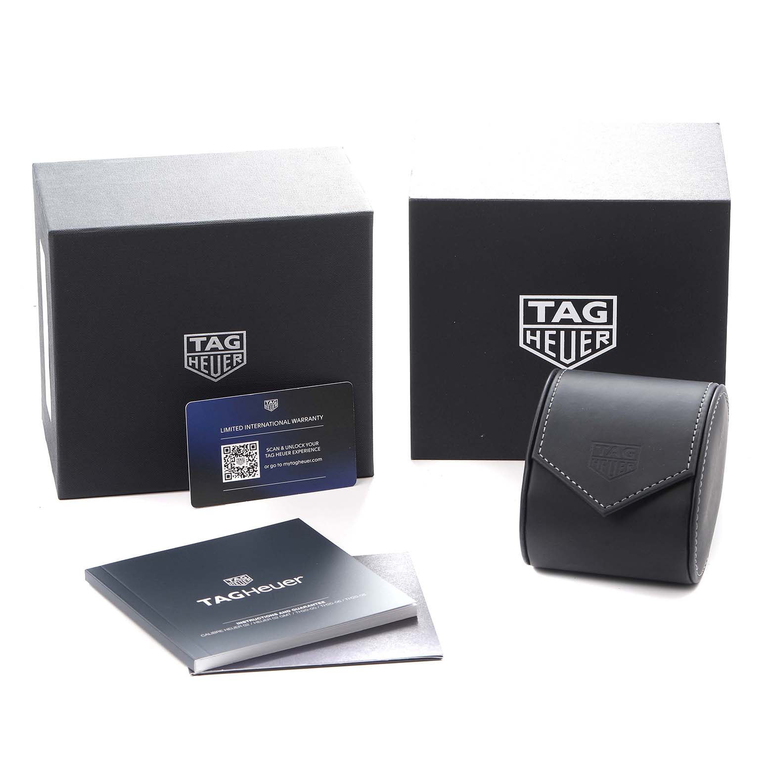 The image shows the Tag Heuer Carrera CBS2213 Men
s Stainless Steel Blue Dial watch box, warranty card, booklet, and a watch case from a front angle.