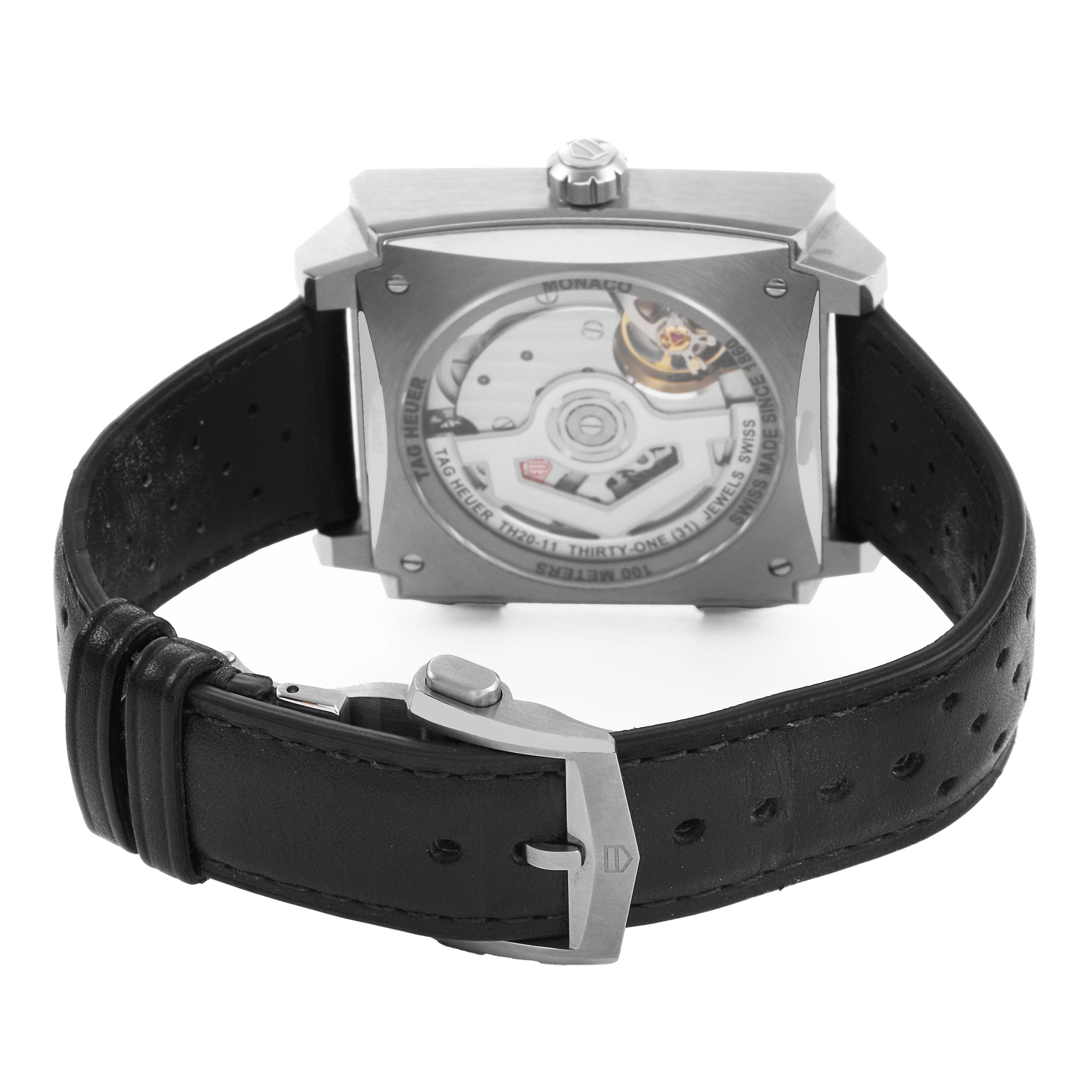 The Tag Heuer Monaco CDW2181 Men's Titanium Blue Dial watch is shown from the back, displaying its movement and leather strap.