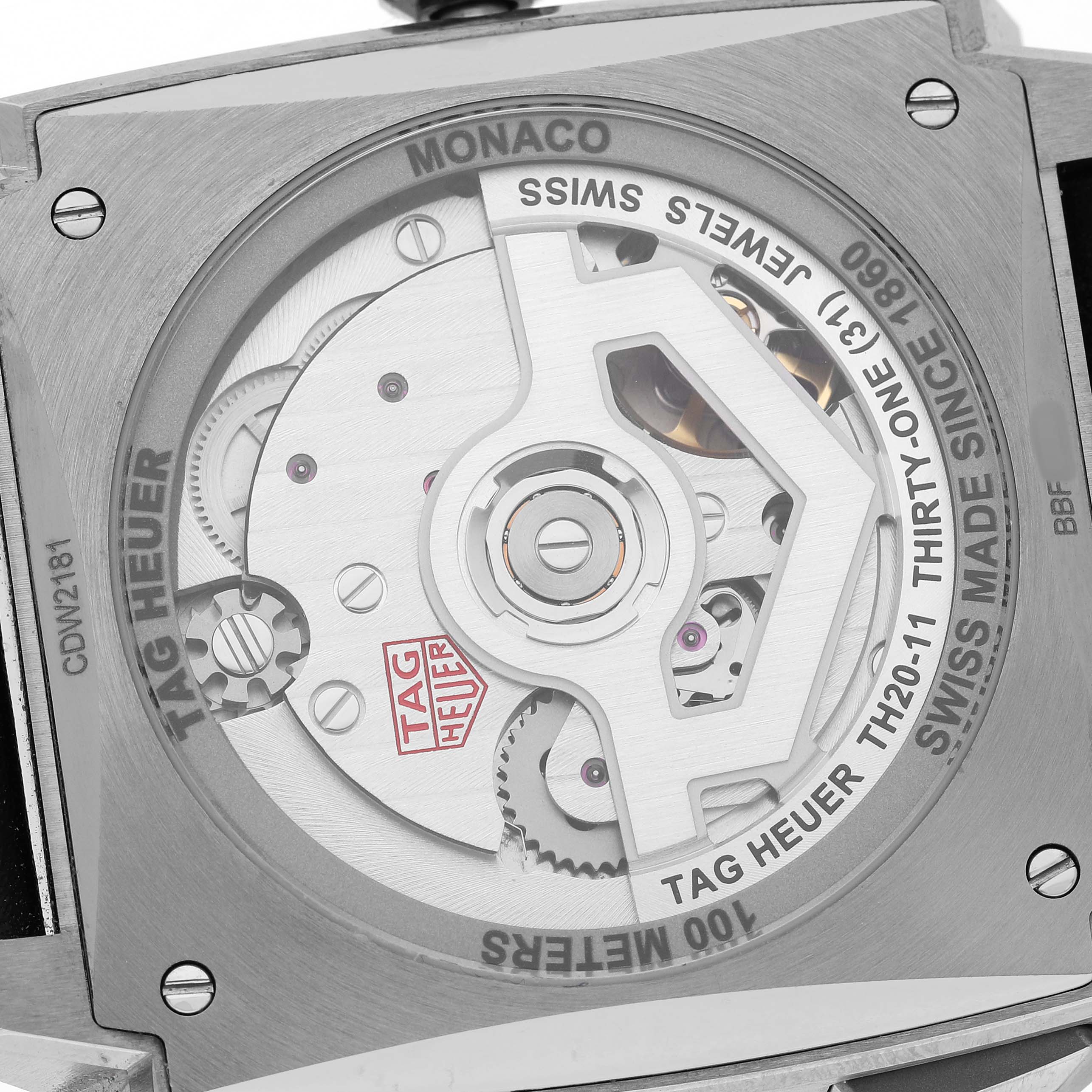 The image shows the back view of the Tag Heuer Monaco CDW2181 Men's Titanium Blue Dial, displaying its inner mechanism and engravings.