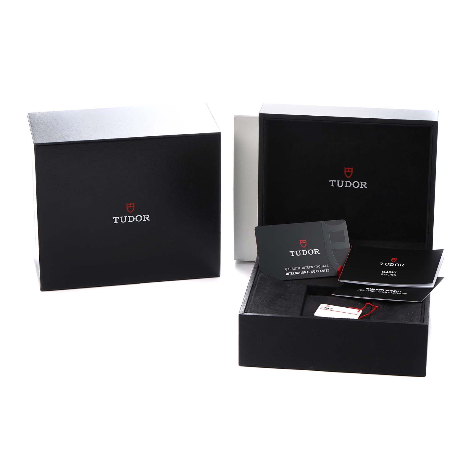 The image shows Tudor Heritage Black Bay 79030B Men
s Stainless Steel Blue Dial watch packaging, including boxes and accompanying booklets and tags, viewed from above.