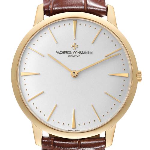 The image shows a front view of a Vacheron Constantin Patrimony watch with a gold case and brown leather strap.