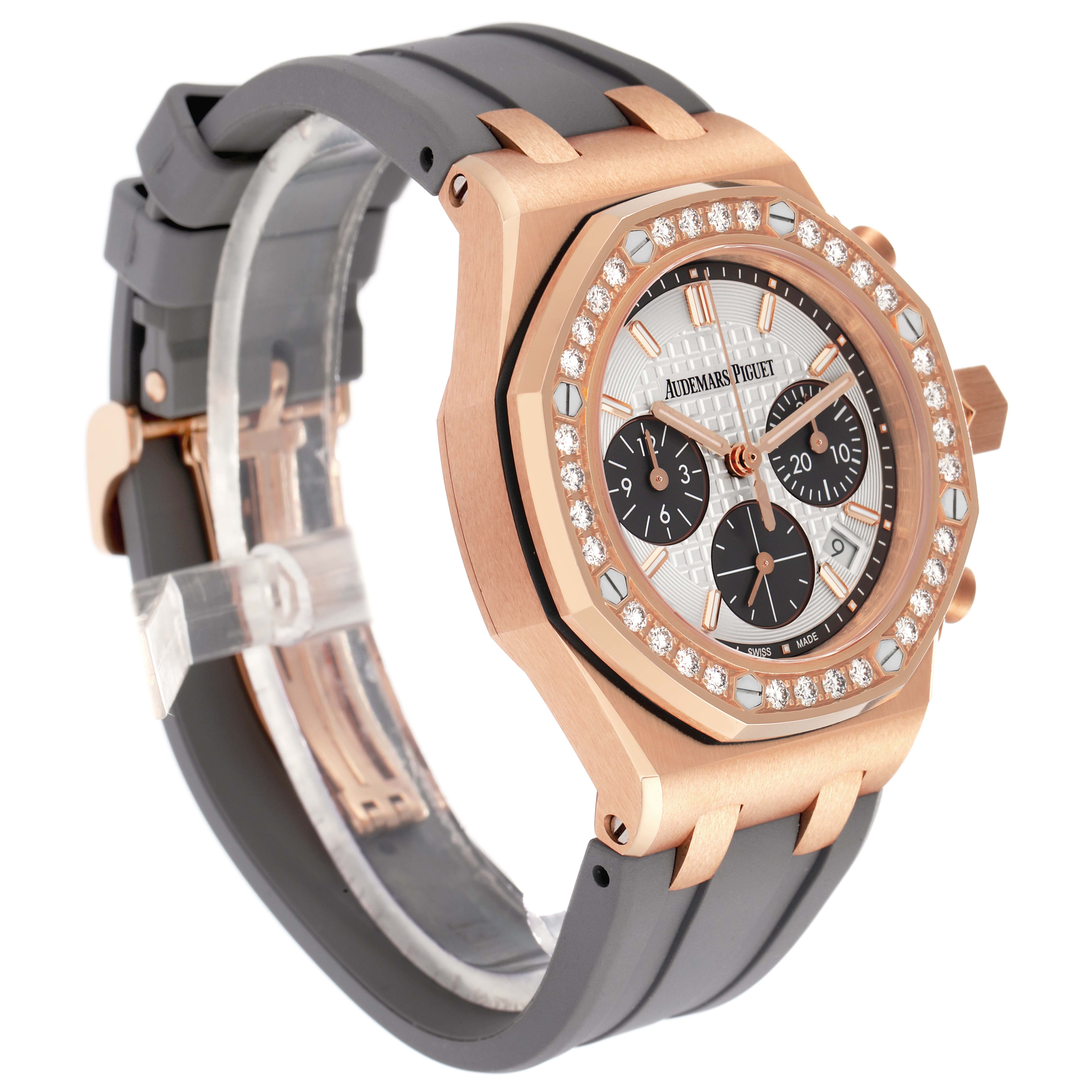 The Audemars Piguet Royal Oak Offshore 26231OR Men
s Rose Gold Silver Dial watch is shown at an angle displaying the dial, bezel with diamonds, chronograph subdials, and rubber strap.