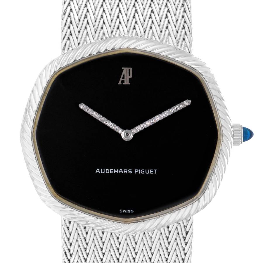This image shows a frontal view of a vintage Audemars Piguet men's watch, highlighting its black dial, unique case shape, and woven metal strap.
