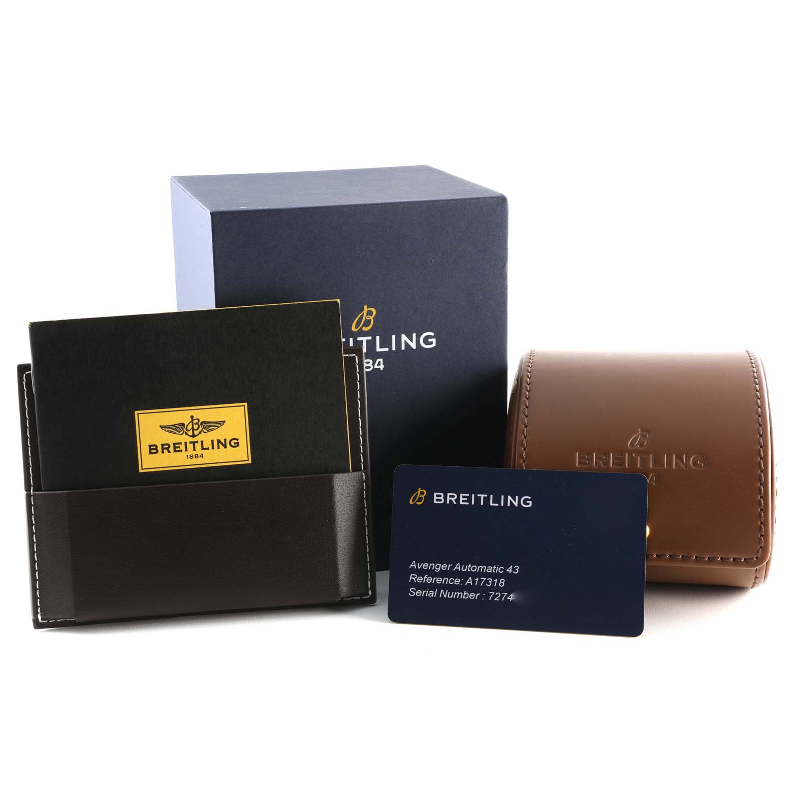 The image shows packaging accessories for a Breitling Avenger A17318 Men's Stainless Steel Blue Dial A17318 Men's Stainless Steel Blue Dial, including a box, leather pouch, cardholder, and warranty card.