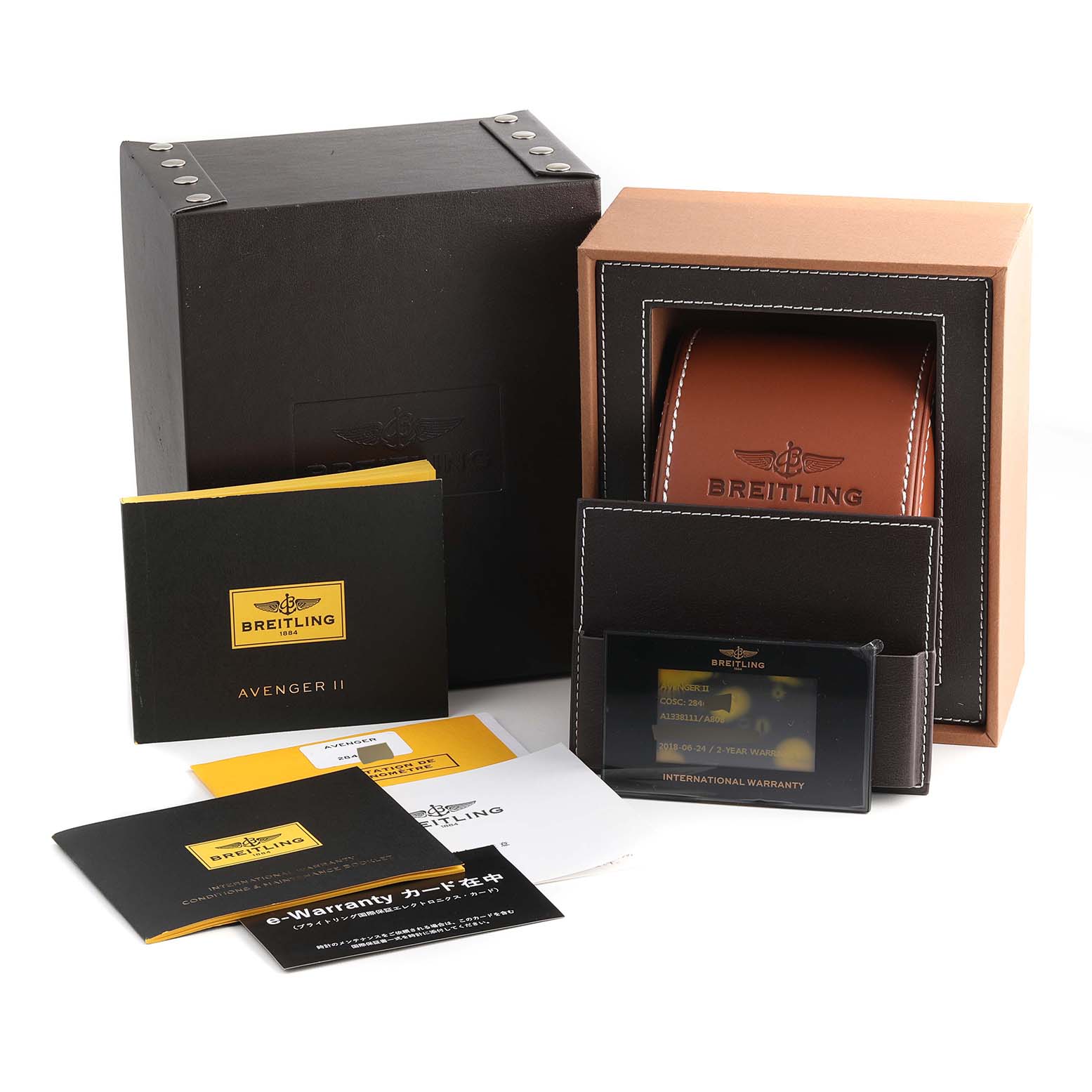 The image shows the packaging, warranty card, and manuals for a Breitling Avenger A13381 Men's Stainless Steel Mother of Pearl Dial A13381 Men's Stainless Steel Mother of Pearl Dial II watch from a front angle.