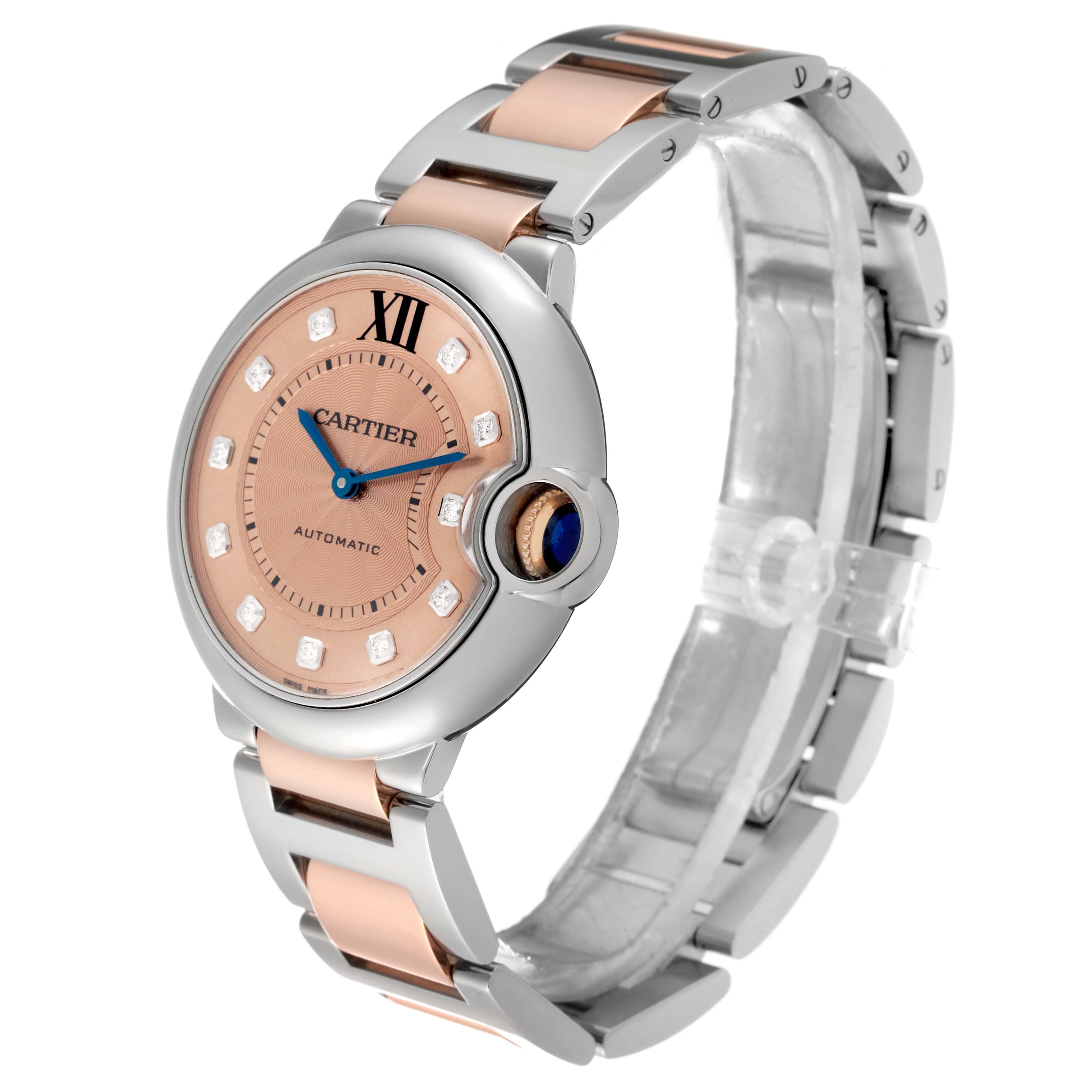 The Cartier Ballon Bleu WE902054 Women's Steel and Gold (two tone) Pink Dial WE902054 Women's Steel and Gold (two tone) Pink Dial watch is shown from a three-quarter angle, highlighting its face, bracelet, and crown.