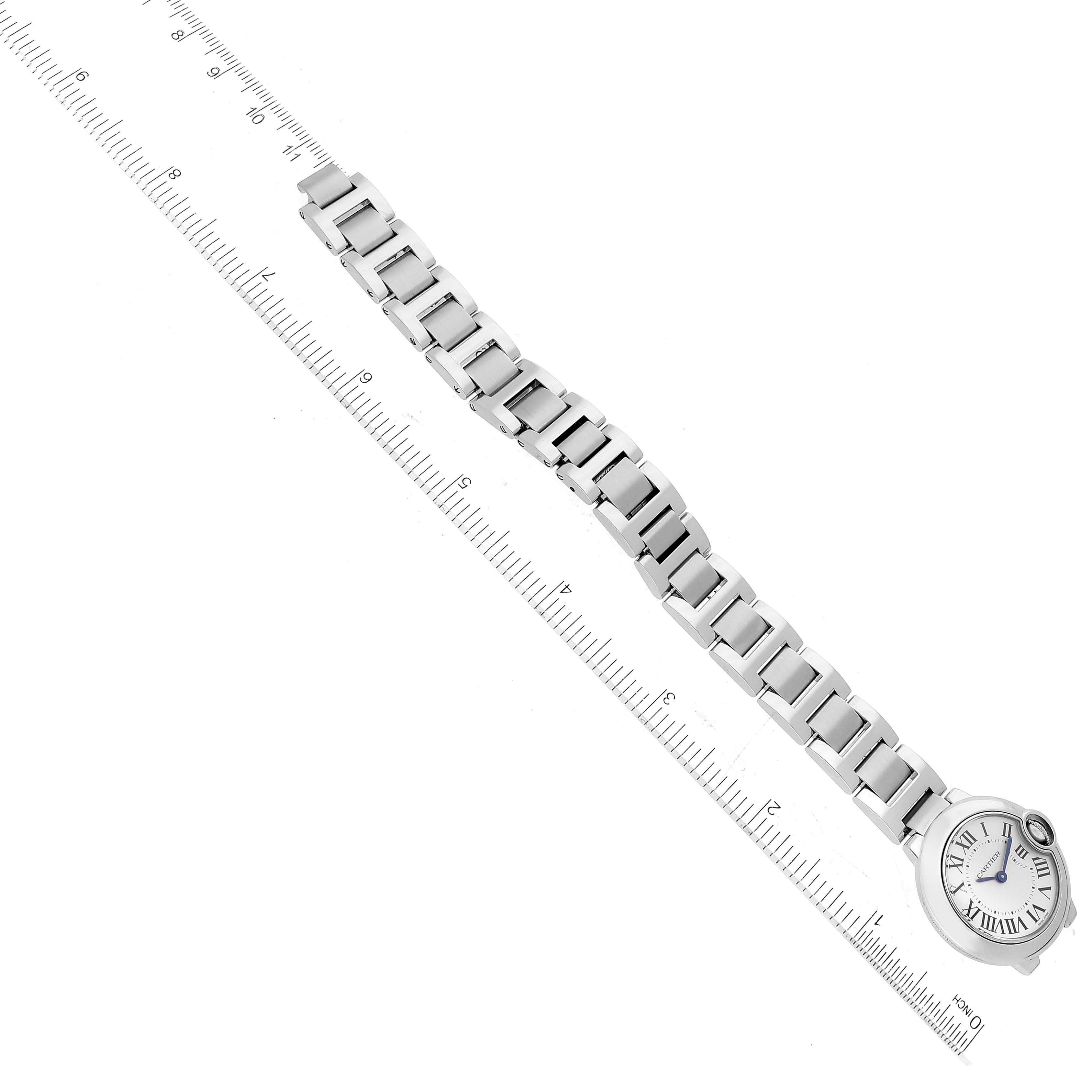 The image shows a Cartier Ballon Bleu W69010Z4 Women's Stainless Steel Silver Dial W69010Z4 Women's Stainless Steel Silver Dial watch with its bracelet laid straight, aligned along a ruler for measurement.