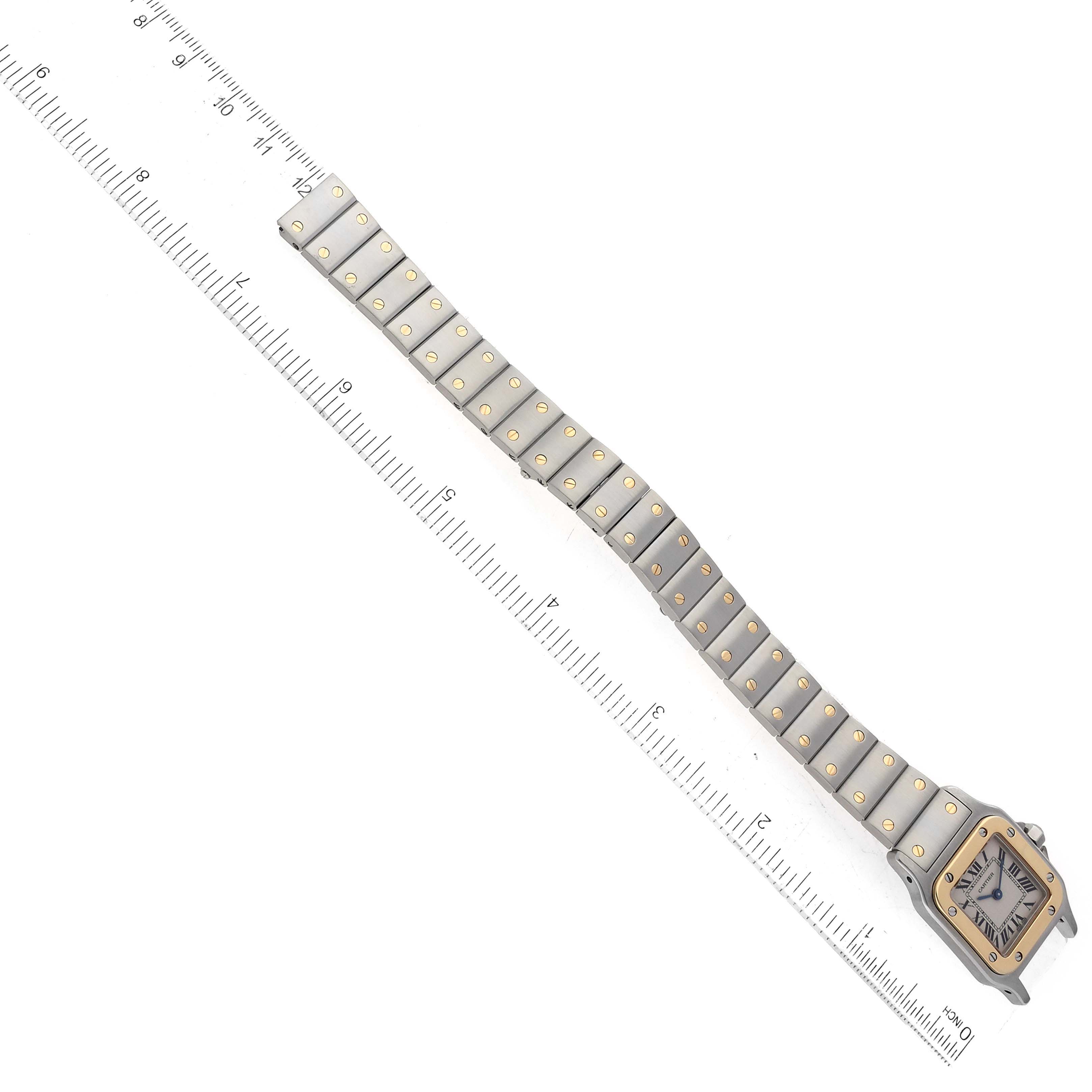 The Cartier Santos W20012C4 Women's Steel and Gold (two tone) Silver Dial W20012C4 Women's Steel and Gold (two tone) Silver Dial watch is shown from an overhead angle, highlighting the face and full length of the metal bracelet.