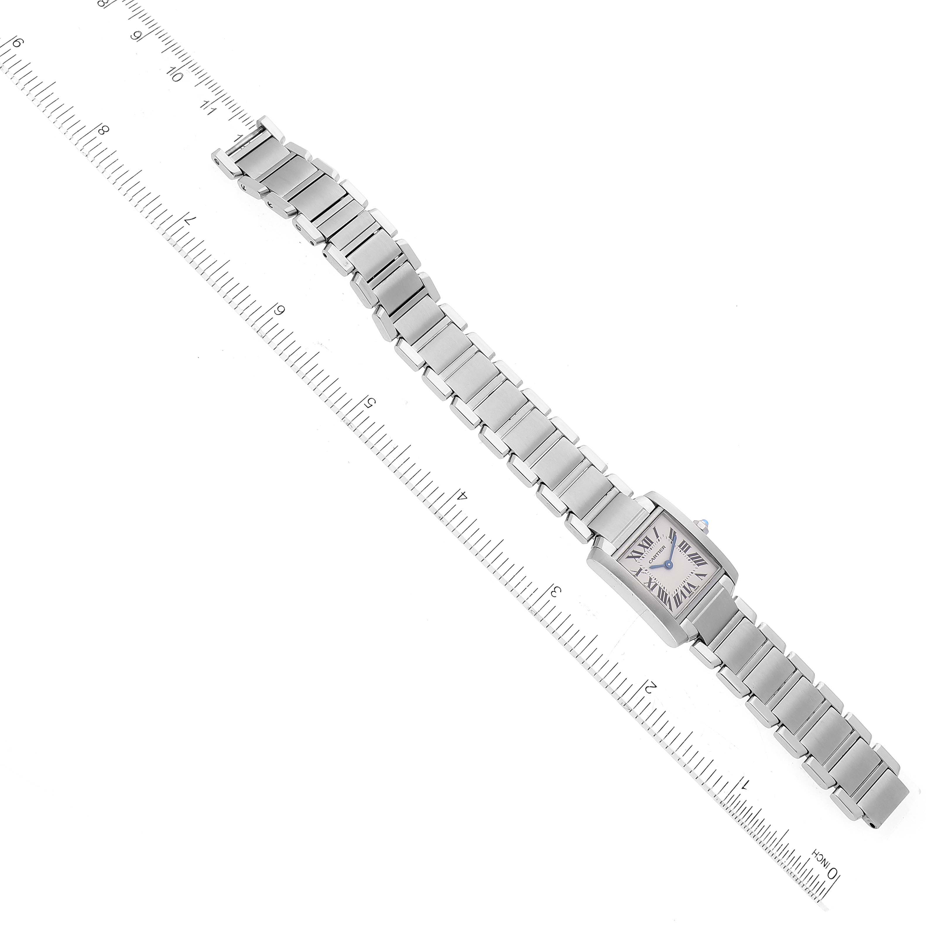 The image shows a Cartier Tank Francaise W51008Q3 Women
s Stainless Steel Silver Dial W51008Q3 Women
s Stainless Steel Silver Dial watch laid flat with its face and full metal bracelet visible, alongside a ruler for scale.