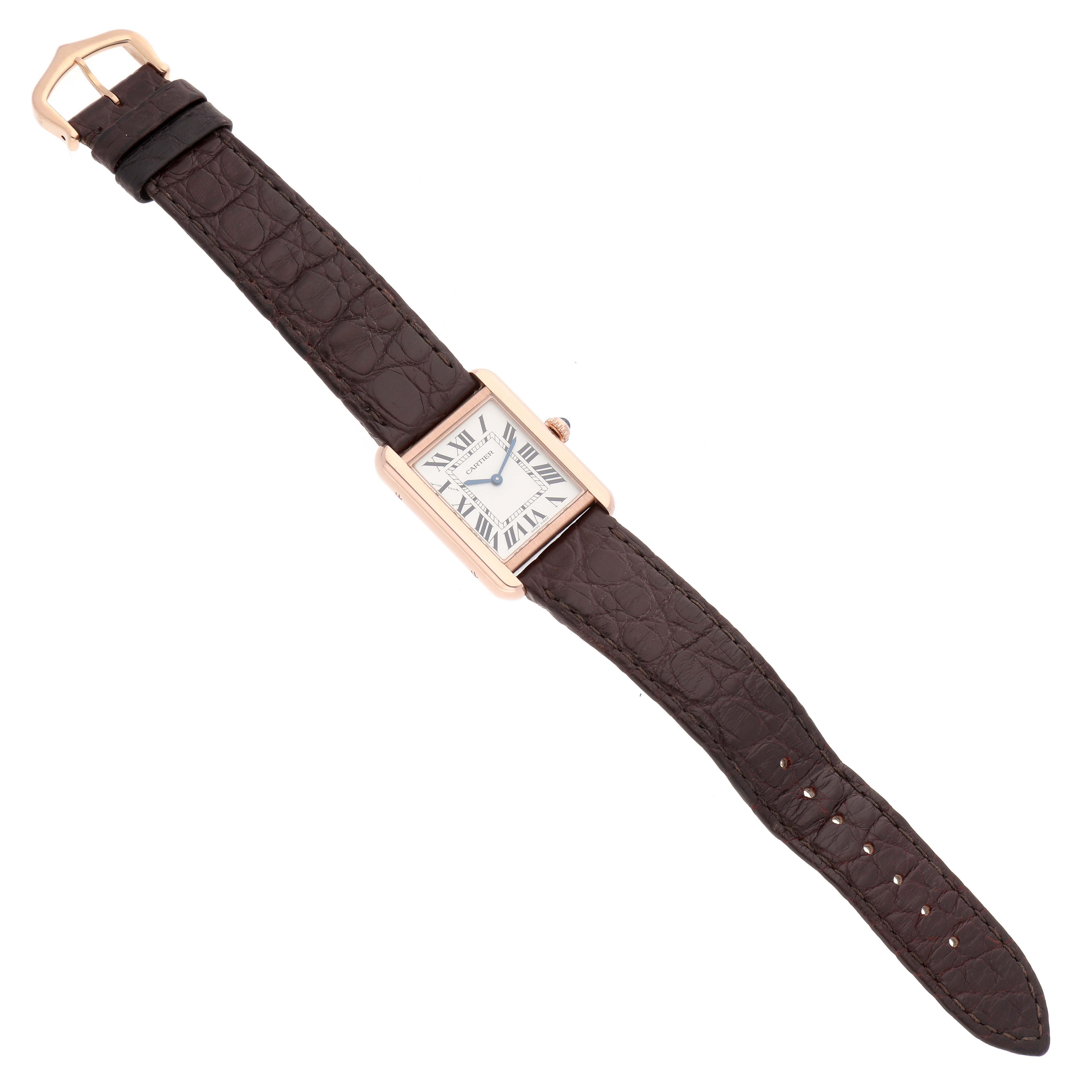 The Cartier Tank Solo W5200002 Women
s Steel and Gold (two tone) Silver Dial watch is shown from a top-down angle, displaying its rectangular face and brown leather strap.