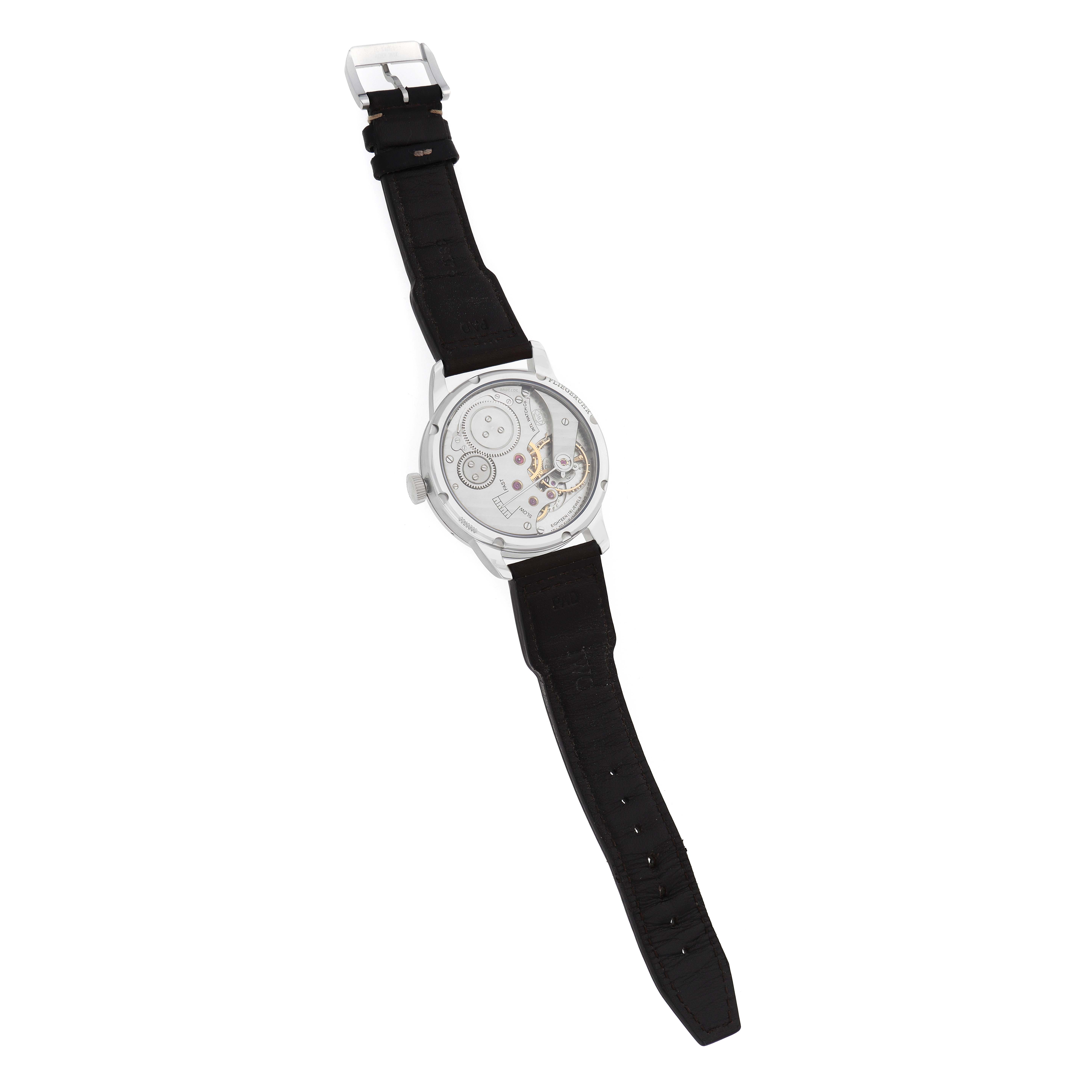 The image shows the back view of an IWC Pilot IW325401 Men
s Platinum Black Dial model watch, highlighting its transparent case and visible movement.