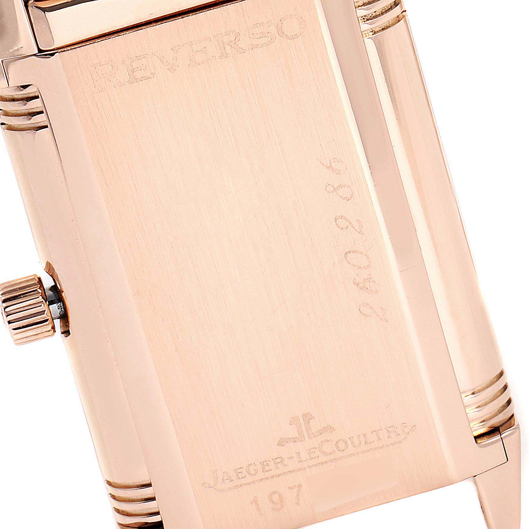A close-up of the back of the Jaeger-LeCoultre Reverso watch, showing the crown and engraved text.