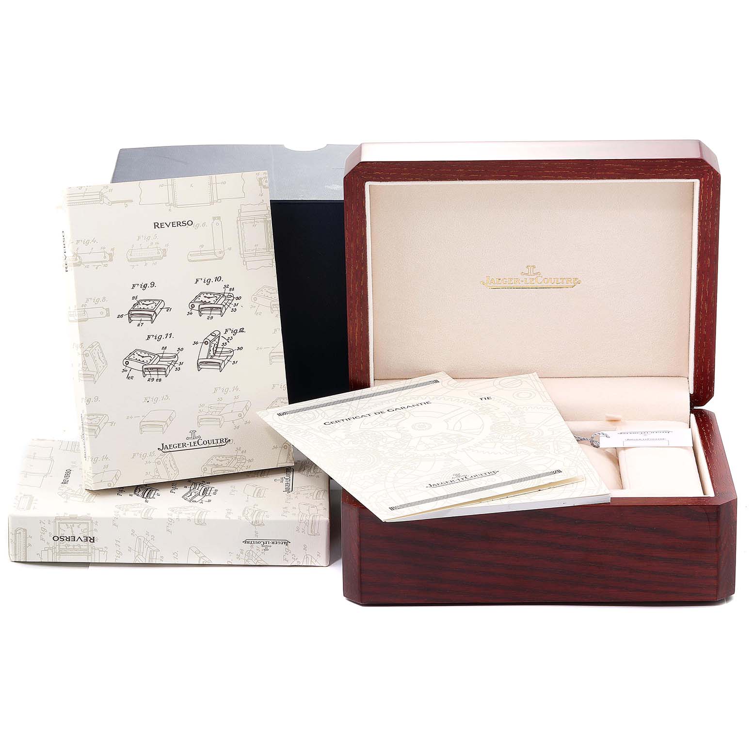 The image shows a Jaeger-LeCoultre Reverso watch box, manuals, and certificates from a front angle.