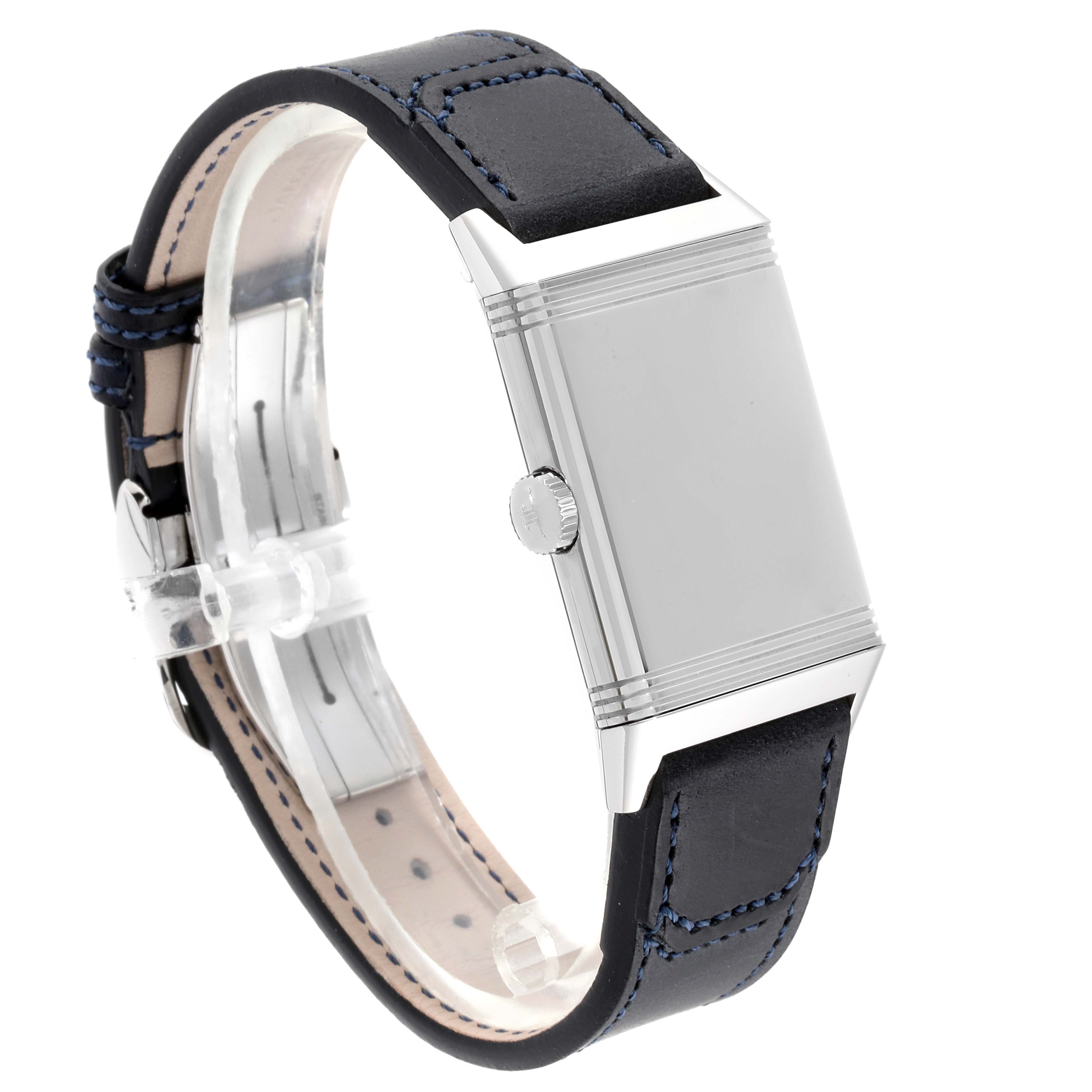 The image shows a side view of a Jaeger-LeCoultre Reverso watch, highlighting the case, crown, and leather strap with blue stitching.