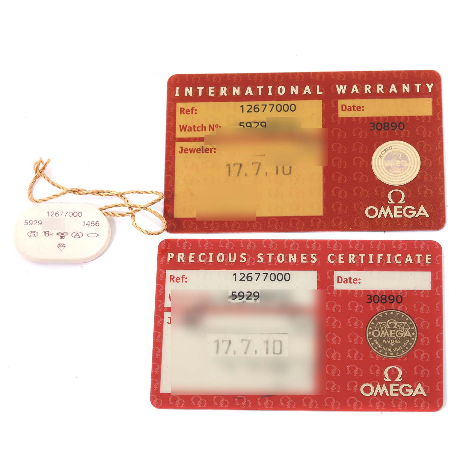 This image shows International Warranty and Precious Stones Certificate cards along with a tag for the Omega 1267.70.00 Women's Steel and Gold (two tone) Mother of Pearl Dial 1267.70.00 Women's Steel and Gold (two tone) Mother of Pearl Dial Constellation Steel Yellow Gold Mother of Pearl Diamond Watch model 1267.70.00.