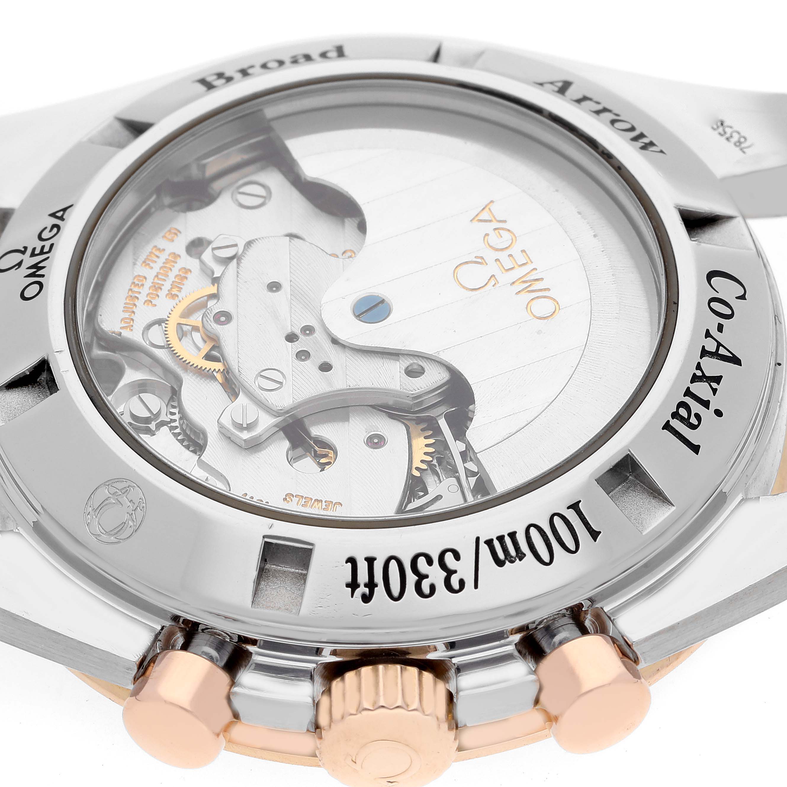 The image shows the back view of an Omega Speedmaster 321.90.42.50.13.001 Men's Steel and Gold (two tone) Brown Dial 321.90.42.50.13.001 Men's Steel and Gold (two tone) Brown Dial watch, highlighting its Co-Axial movement and water resistance.