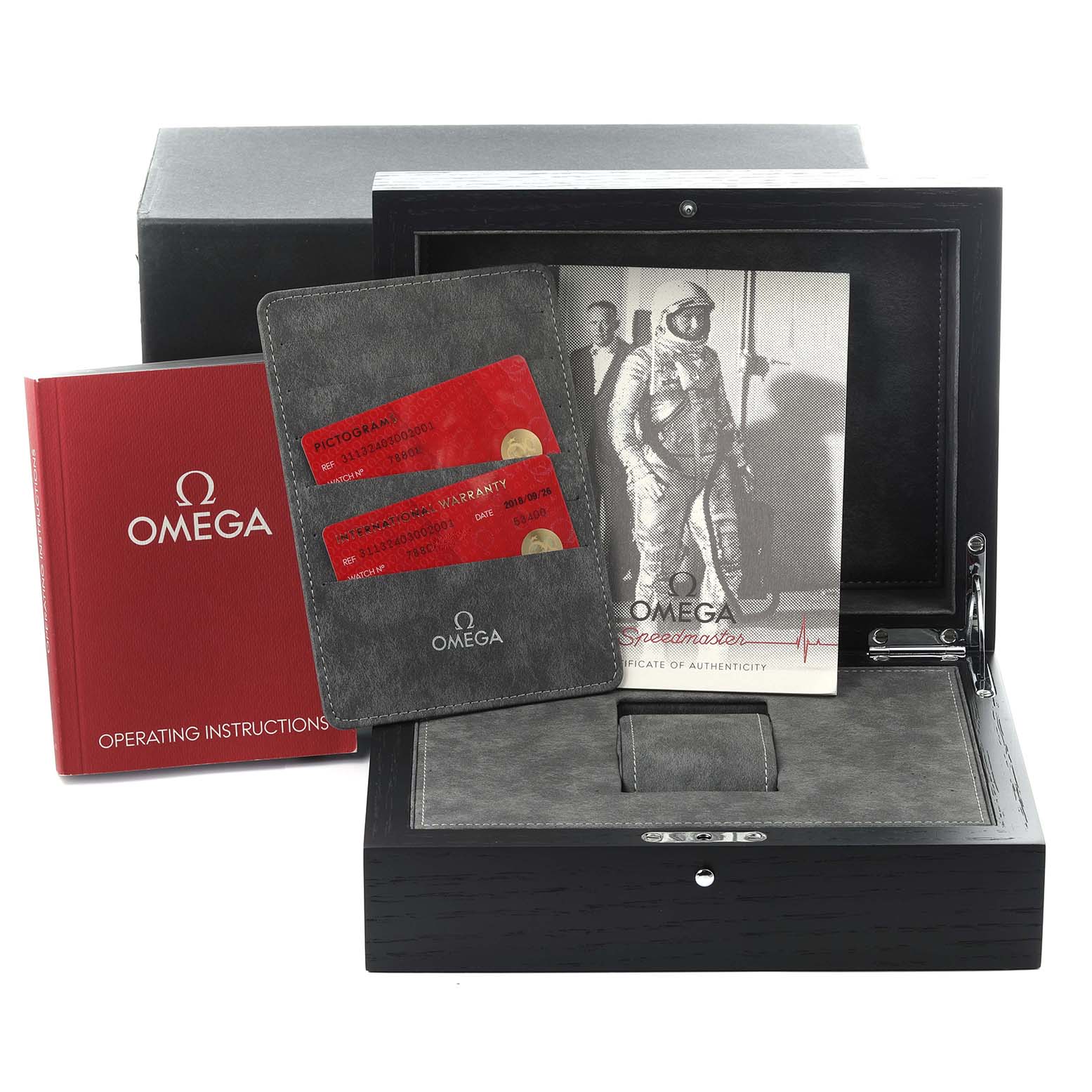 The image shows the Omega Speedmaster 311.32.40.30.02.001 Men's Stainless Steel Silver Dial box, manual, warranty cards, and certificate from a front angle.