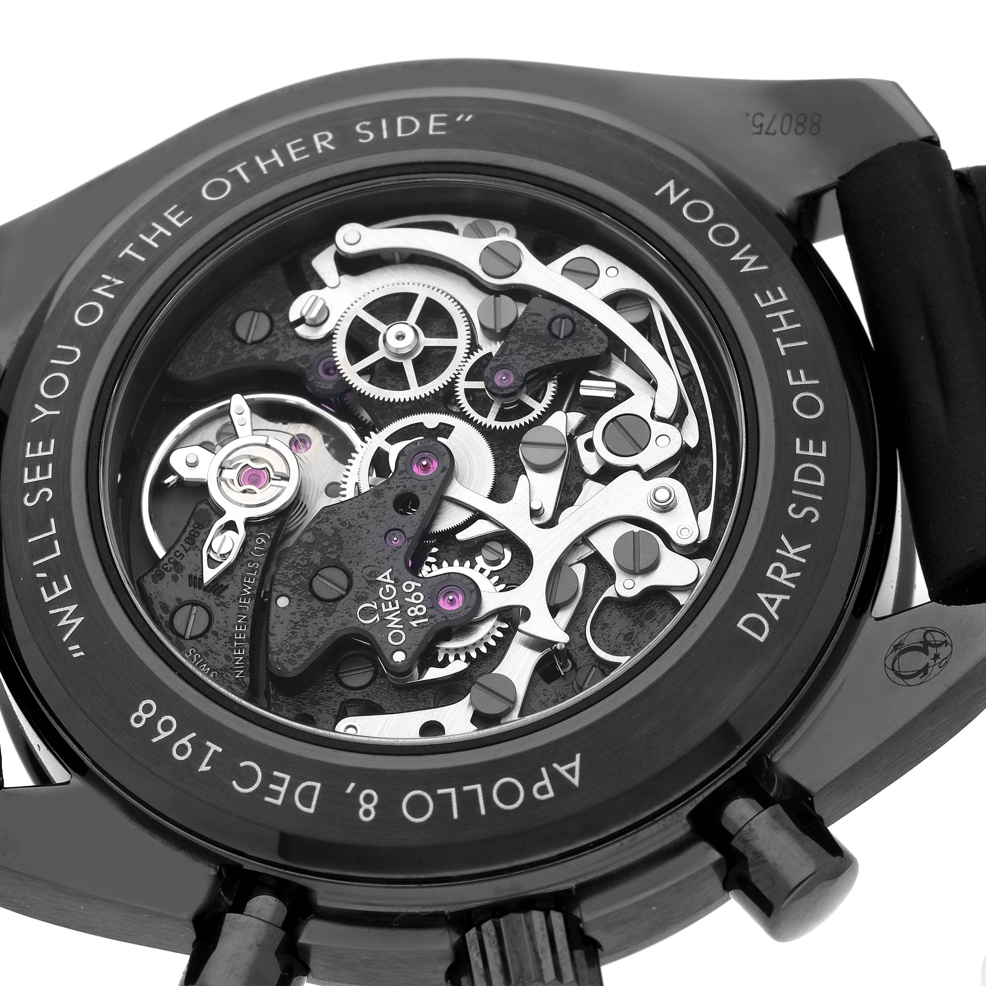 The image shows the back of the Omega Speedmaster 311.92.44.30.01.001 Men
s Ceramic Black Dial watch, highlighting its intricate mechanical movement and engravings.