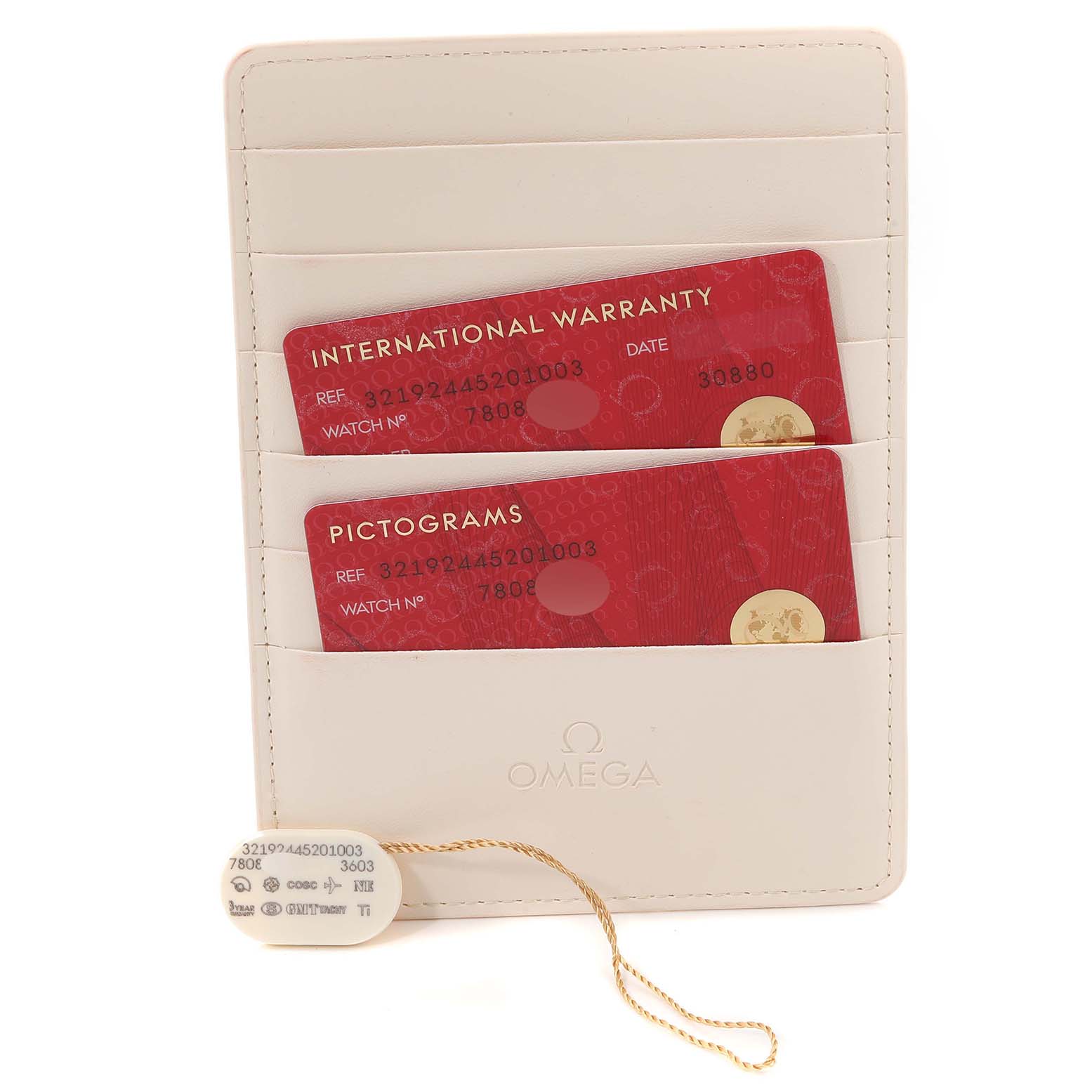 The image shows the warranty cards and pictograms card for the Omega Speedmaster 321.92.44.52.01.003 Men's Titanium Black Dial 321.92.44.52.01.003 Men's Titanium Black Dial kept in a white cardholder, along with a tagged label.