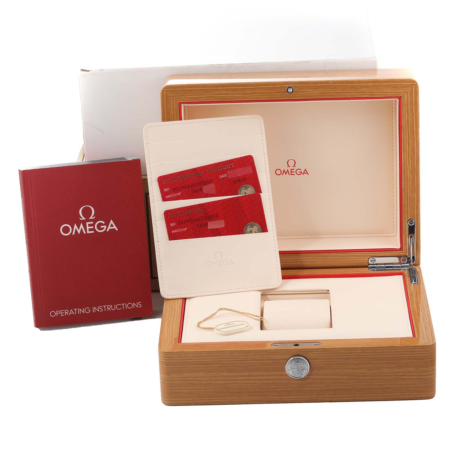 This image shows the open case of an Omega Speedmaster 321.92.44.52.01.003 Men's Titanium Black Dial 321.92.44.52.01.003 Men's Titanium Black Dial watch, including the operating instructions and warranty cards.