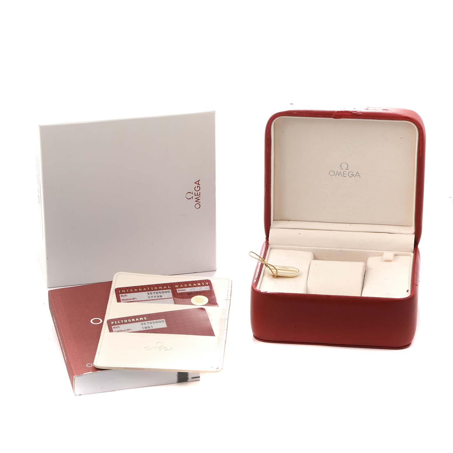 The image shows Omega Speedmaster 3570.50.00 Men
s Stainless Steel Black Dial watch accessories including a box, instruction manual, warranty cards, and a clear container clasp.